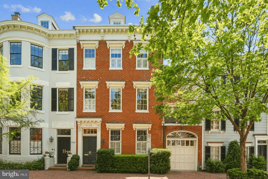 Located on one of Georgetown’s most iconic East Village blocks, surrounded by some of the neighborhood’s most distinguished historic homes, this circa 1845 Federal residence blends classic architecture, exceptional scale, and thoughtful updates across four levels of light-filled living space, complete with a rare 1-Car Garage, just moments from Georgetown’s cafés, shops, and waterfront. Expanded in 1890, the home carries a quiet but meaningful history. An early restoration by a young Archie and Selwa "Lucky" Roosevelt in the 1950s helped define the home's enduring character and extraordinary sense of light and openness, most notably through the addition of an expanse of windows that frame the deep garden and bring “the outside in,” creating a seamless connection between interior living spaces and surrounding greenery.  Behind its elegant façade, the home unfolds with generous proportions, soaring ceilings, four fireplaces, and refined period details including large-paned windows and original millwork. The main level is anchored by gracious living and entertaining spaces, including a handsome library with wood-burning fireplace, marble-floored foyer, light-filled dining room, and a fully renovated chef’s kitchen with premium appliances. The kitchen opens to a sun-filled breakfast room with windows on three sides and French doors leading to a private landscaped garden and patio, an ideal extension of the living space, effectively bringing the "outside in," as its design intended. The garage offers main level access as well through the butler's pantry into the kitchen. The upper levels continue the home’s balance of scale with comfort, featuring a grand double parlor with a sun room and wet-bar, perfect for entertaining, a serene primary suite with skylit bath, and flexible additional bedrooms and study spaces. Thoughtful improvements enhance everyday living, including upgraded baths, a dedicated upstairs laundry, a private second-floor patio, and a reconfigured top floor with expanded dormer and open views. Outdoors, the deep landscaped garden offers rare privacy and calm in the center of the city, an escape that feels far removed from its central Georgetown location. Modern systems, including supplemental HVAC, integrated speakers, security, and solar panels, support effortless living. This is a home defined by light, classic architecture, and an extraordinary garden connection, an elegant and deeply livable retreat with its own attached garage in the heart of one of Washington’s most coveted neighborhoods. Don't miss this hidden gem in the heart of Georgetown!