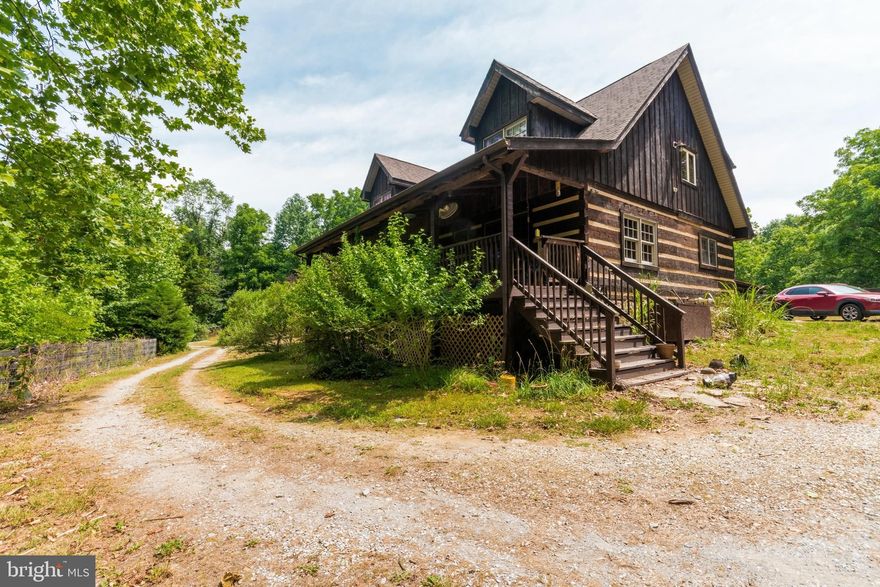 PRICE IMPROVEMENT!  Timber Frame log home about a half mile or so from the Potomac River!  Featuring  vaulted ceilings on the 2nd floor with exposed beams through out, this home is one of a kind.  35x8 covered front porch with a 20x8 sunroom on the back, this home will bring you back to nature!   Large barn on the property with electric will take care of your storage needs.  The entire 6 acres is fenced and broken down into paddocks for animals or gardening.   Horses are allowed but no poultry!  The furnace, water heater, well pump and water softener have all been replaced recently.  Unfinished basement is ready to be finished with french doors to walk out and was built with a couple of extra courses of block for more ceiling height if you want it!  Some nice quality features like pocket doors in the bathroom, solid wood doors through out the house.  foundation is stone to grade on the exterior.   Barn is 35x40 (+/-) with a loft and has electric run to it and its own paddock area.  The Clawfoot tub in the primary bath has jets in the bottom.  Property consists of 2 lots of which another home can be built on the second lot.