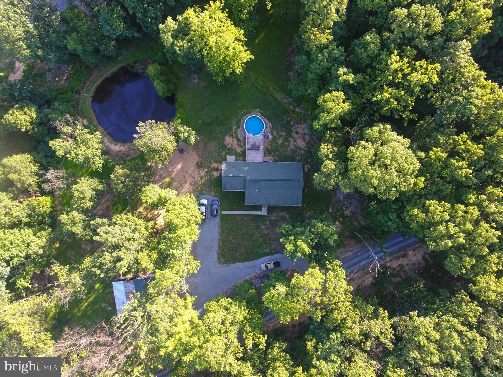 Looking for Privacy, Seclusion, Your very own pond, No HOA s, Well maintained, One Level Living - you have found it !!! This 5 Bedroom, 3 Bath Rancher offers Hardwood Floors, Tiled Kitchen & Baths, Granite Counters, Stainless Steel Appliances, Large Family Room, Covered Front Porch 7 x 46, Rear terraced decks 12 x 16 & 10 x 16 with above ground pool. Basement is partially finished with Full Kitchen, Full Bath Washer & Dryer, Either 2 Bedrooms or 1 Bedroom & Living room -Mother -n -law suite possibilities -with outside entrance also. Over 700 + sq ft in basement for storage or to be finished to your lifestyle. -Mother -n -law suite possibilities . Over sized detached Garage/Barn 18 x 30 with w fenced area for livestock. Situated on 2.39 Unrestricted Acres - partially wooded. Located in Southern Berkeley County approx 5 Miles from I-81, Shopping - A TRULY MUST SEE TO APPRECIATE !!!
