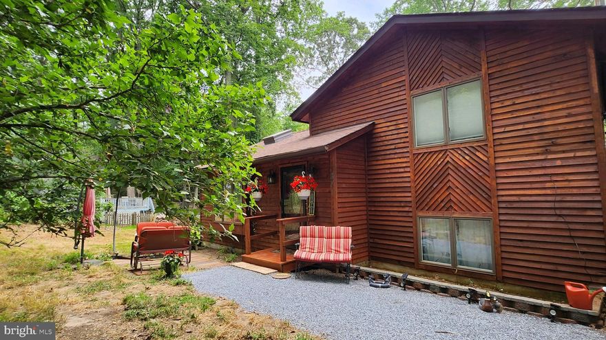 This Cozy house situated in the Chesapeake Ranch Estates is awaiting you!
Step inside your new home and you will see an open living room to the kitchen with vaulted ceilings and vented skylight .During the day, plenty of natural light will illuminate your living room. The living room opens into the open Kitchen/Dining room. The above Range Microwave is also a convection Oven. Stepping down to the lower level you will be greeted by Mario and Princess Peach hand painted on the wall to either side of the wood burning stove. This second living space is a perfect children's play area with a full bathroom attached. Add a pullout bed and you have a ready guest area with a full bathroom for visiting family and friends alike. Stepping out of the lower living space you will enter the mud room and Laundry Area. Here you will find the 80 Gallon water heater and the Water Furnace Geothermal HVAC System. The water heater is supplemented by the Geothermal with a de-superheater reducing the cost to maintain hot water in the house when the AC unit is cooling .The whole house air is filtered through the Trane Air Effects Electrical air filter .Inside the downstairs closet is access to the crawl space.The Crawl Space has been encapsulated and sealed by clean space when the Geothermal Unit was installed. HVAC is lined inside and is environmentally controlled and great  for storing your possessions. Heading upstairs from the Kitchen you will find the three upstairs bedrooms and upstirs bathroom. The first bedroom on the left is perfect for your child.On one wall is a large undersea wallpaper mural that will fascinate them and on the other is another Hand painted Mario and Yoshi. This property contains a flat back yard with a spacious .43 Acres of property .The back yard is mostly cleared of trees  and will experience plenty of sunlight With a Childrens playset,15' diameter trampoline and climbing dome, your children will enjoy their time in the sun. For the parents there is a hot tub installed in the back deck that just beckons you to relax.If a hot tub is not what you want,you can enjoy the 50'' diameter fire pit with the already vastly stocked wood reserves. There are 3 Sheds on the property, One large Dutch barn style at the end of the driveway, 1 standard medium shed, and 1 shed/playhouse . The driveway was recently widened and is ready for your paving desires .The cedar siding and decking was just pressured washed and freshly stained  (finished June 19th 2023). The front porch was just replaced in June of 2023.The downstairs and Upstairs Bathroom tub/showers are in the process of being replaced and will be finished prior to closing. The back porch roof is also in the process of being replaced and will be finished prior to closing. The Dutch Barn Shed at the end of the driveway is undergoing a roof replacement, the front is being rebuilt including the doors, siding being repaired, and the flooring being repaired. There maybe Contractors working in the house during a showing so please Pardon our mess. Come and see your new Home Today!