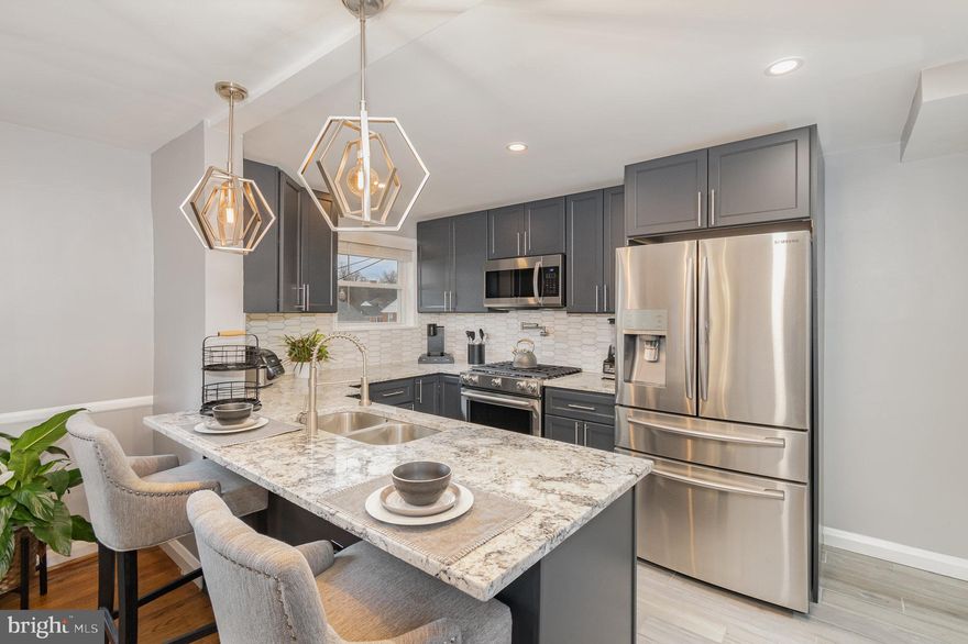 Beautifully upgraded 4bdr 2.5 bath spacious town home will delight you the second you enter the front door. Gleaming real hardwood floors, open floor plan with luxury kitchen including granite countertops, splash back, pot filler faucet, stainless steel appliances, and an elegant large kitchen island. Upstairs you will find three bright and generously sized bedrooms as well as a luxurious bath with a soaking tub, separate walk in shower, modern vanity, and ceramic tile floor. Fully finished lower level presents the perfect living space with an entertaining buffet plus mini fridge, an additional bedroom and full bathroom.  Free flowing open layout with plenty of storage. Recent updates also include windows, roof, HVAC and a water heater. Conveniently located close to I-83, shopping, and walking distance to Belvedere Square and the Historic Senator Theatre.