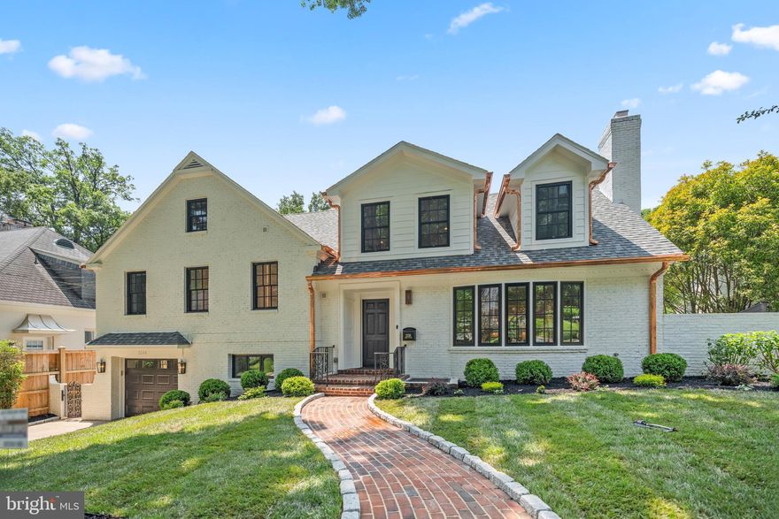 Traditional charm meets contemporary design from Award Winning Builder Dilan Homes' latest masterpiece, located at 2236 46th Street NW. Tucked away on one of Berkley’s most picturesque and tranquil streets, this brick Tudor-inspired home has been impeccably updated and thoughtfully reimagined. Its understated curb appeal begins with an original bay window and striking copper gutters against painted white brick that warmly welcomes guests. A deep-water heated gunite pool, framed by aged brick hardscaping, and lush landscaping, creates the feeling of a private estate where timeless architecture seamlessly blends with modern luxury. Inside, the home offers a beautifully considered layout across three fully finished levels, featuring wide-plank herringbone patterned European White Oak floors and whimsical paint hues complimented by premium finishes with gold and brass tones throughout. The main level consists of a grand formal living room with a wood-burning fireplace, an elegant dining area that is open to the gourmet eat-in kitchen with a quartzite island and backsplash as well as a convenient powder room. A short staircase leads to double doors that open to the private master suite—a true retreat featuring dual walk-in closets with built-in LED lights, a spacious spa-like bathroom, a second laundry area, and a sunroom that overlooks the pool and secluded backyard. Upstairs, you'll find three generously sized bedroom suites, each with walk-in closets and two luxurious en-suite bathrooms. The expansive lower level includes a private Au Pair suite, a laundry/mudroom, an office or optional bedroom, a recreation room with another wood-burning fireplace, a fitness or pool changing area opening to the rear yard, and ample natural light throughout. A walkout portico leads directly to the manicured backyard, featuring the deep-water pool, extensive hardscaped patios, brick retaining walls, planted gardens, and a bonus lawn area. 2236 46th Street NW perfectly embodies understated modern elegance behind a beautifully restored, architecturally rich façade—all within walking distance of parks and local amenities, including W Street Park, Glover Archbold Park, Palisades Rec Center, BlackSalt, and a variety of shops and restaurants.