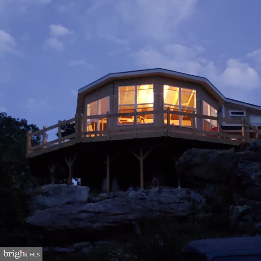 An Eagles View, Custom off grid cabin built to take in the spectacular western sunsets from atop Sidling Mt. Accessing this truly unique cabin you'll follow a rugged path through the boulders, then up onto the deck where you'll find wood fired sauna and comfortable area for outdoor relaxation. Entering the cabin, you'll hardly feel that you're indoors with the many large windows and high ceiling taking advantage of the great room design. with 2 bedrooms, one of them being a loft style with sitting area below. If you ever wanted a one of a kind get a way, you'll need to look at this one.