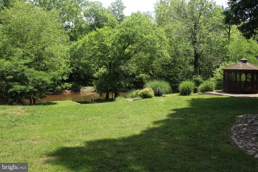 Vacation from Home!  STUNNING!  Water Front (double lot) with 185 feet+/- on the Bull Run River!  1.7+ Acres!  Secluded with Boat house, Detached Garage, Gazebo, 2 Fire Pits, Basketball court, Large Shed and More!  Grandfathered stone steps that lead right to River!  Kayak from your backyard! Home Renovated in 2012 with Addition, new roof, HVAC, Kitchen and Baths! Close in yet you feel like you own the RIVER!  No HOA! Backs to 18 Miles of Parkland!  Must See!  Famous Artist Painted Mural on outbuildings!