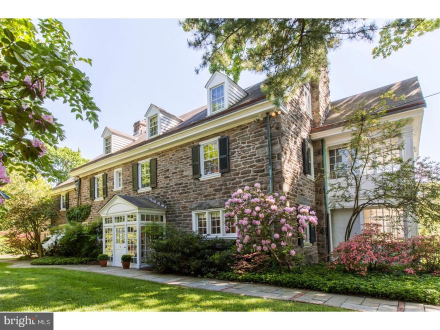 Absolutely stunning 1911 Chestnut Hill stone Colonial Revival home in wonderful, walkable, Top-of-the-Hill location.  Designed by noted architects Duhring, Okie & Ziegler, it features all of the elegant hallmarks of the Colonial style, including a gracious center hall, multiple fireplaces, beautiful millwork, hardwood floors, and lovely flow, along with modern updates that are sure to appeal to current buyers.  A fabulous remodeled kitchen has quartzite counters, custom cabinets, 6-burner dual-fuel stove, electric wall ovens, and Liebherr fridge, and is open to the breakfast/family room addition, all with oak floors with radiant heat.  Also on the first floor are elegant living and dining rooms, both with fireplaces, an enclosed sun porch, butler's pantry, powder room, and mud room.  Upstairs, the master suite has a large bedroom with fireplace and sleeping porch, spacious walk-in closet/dressing room, and a gorgeous en-suite bath with custom cabinetry, marble counters, glass enclosed shower, and ceramic tile floor with radiant heat.  There are 2 additional bedrooms (one with fireplace) now used as offices, a hall bath and laundry on the second floor.  On the third floor are 2 more bedrooms, a hall bath, and a terrific game room with beamed cathedral ceiling.  A detached 2-car garage has potential living/working space above.  Set on a beautifully landscaped 6/10-acre lot within walking distance of Chestnut Hill's shops, restaurants, Wissahickon Park and commuter train.