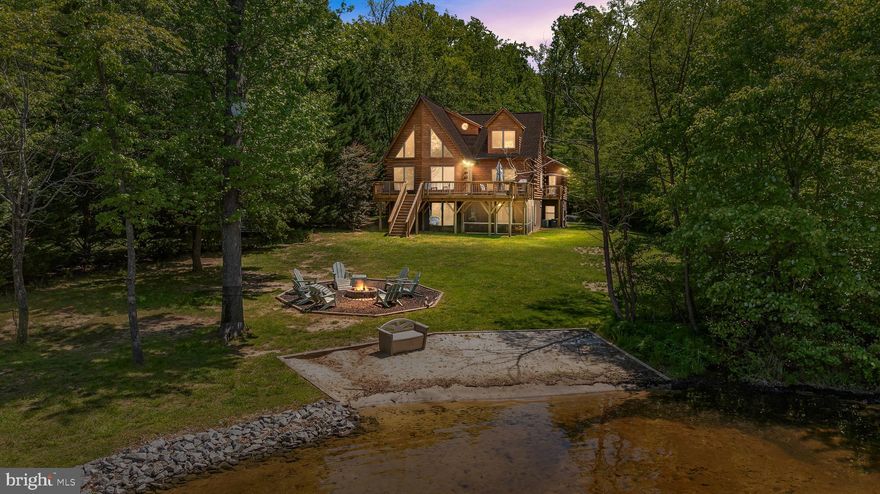 For those Seeking Waterfront Living at its Finest, we offer a Private Paradise with this Gorgeous Waterfront Log Home Located on the Private Side of Lake Anna in the Oakleigh Subdivision. This Stunning Waterfront Masterpiece Features Grand Open Concept Living-Kitchen, Breakfast Bar, Roomy Eat in Gourmet Kitchen w/ Island and all Stainless-Steel Appliances w/ 2 Refrigerators. Upon entering this Amazing 5 Bedroom, 5 Bathroom home, you will notice the Large Paladin Windows, Hardwood Flooring, Log Walls, Soaring Vaulted Ceilings in Great Room with Spectacular Views of the Lake, Spacious Over Look Loft Area, 2 Primary Bedrooms w/attached En-suites. The Primary Bedroom Suite is Located on the Main Level has an En-Suite w/ 2 Separate Vanities, Tiled Shower Stall and a Large Soaking Jetted Tub, Private Access to a Deck Overlooking the Lake. Also on the Main Level is a Large Bedroom w/ Adjoining Full Bath w/ Claw Tub. A Wonderful Expansive Downstairs Area great for family Game Room Fun, Fully Finished Walk-Out Basement w/ Both a Private Entrance and a Screened-In Patio off the Large Suite w/ its Own En-Suite and Soaker Tub. The Top Floor Boasts a Large Loft Area w/ TV, Full Bathroom and Expansive Bonus Bedroom. This Finished 3200 sq ft Home is Perfect for Accommodating Multiple Families. Outside you will find a Large Wrap Around Deck for Grilling and Dining. Down to the Gorgeous Waterfront you will see a Beautiful Dock, Covered Boat Slip w/ Electric Lift, 125 ft of Waterfront w/ Sandy Beach Area Nestled on 1.60 Acres, Calming Privacy Road Frontage, Entrance Lot Area Wooded onto Long Driveway, One Attached Garage w/ Lower-Level Entry. Access to Neighborhood Community Boat Ramp. All Interior and Exterior Furniture Conveys! This Luxury Lake Anna Home is the Perfect Investment Property for Vacation Rentals, Full Time Family Home or Weekend Getaways! Just Minutes to Shopping and Restaurants. Fox Business, Southern Living and Forbes Business Recently named Lake Anna THE #1 TOP “Beach” Vacation Investment Location in the Entire Nation - this Lakefront Cabin would make an Incredibly Lucrative Investment Asset and it COMES FULLY FURNISHED! Many Improvements have also been made to this Property. Don't Miss Out on this Spectacular Opportunity! Long Standing and ‘SUPERB’ Rental History. Available Upon Offer Requests Only.