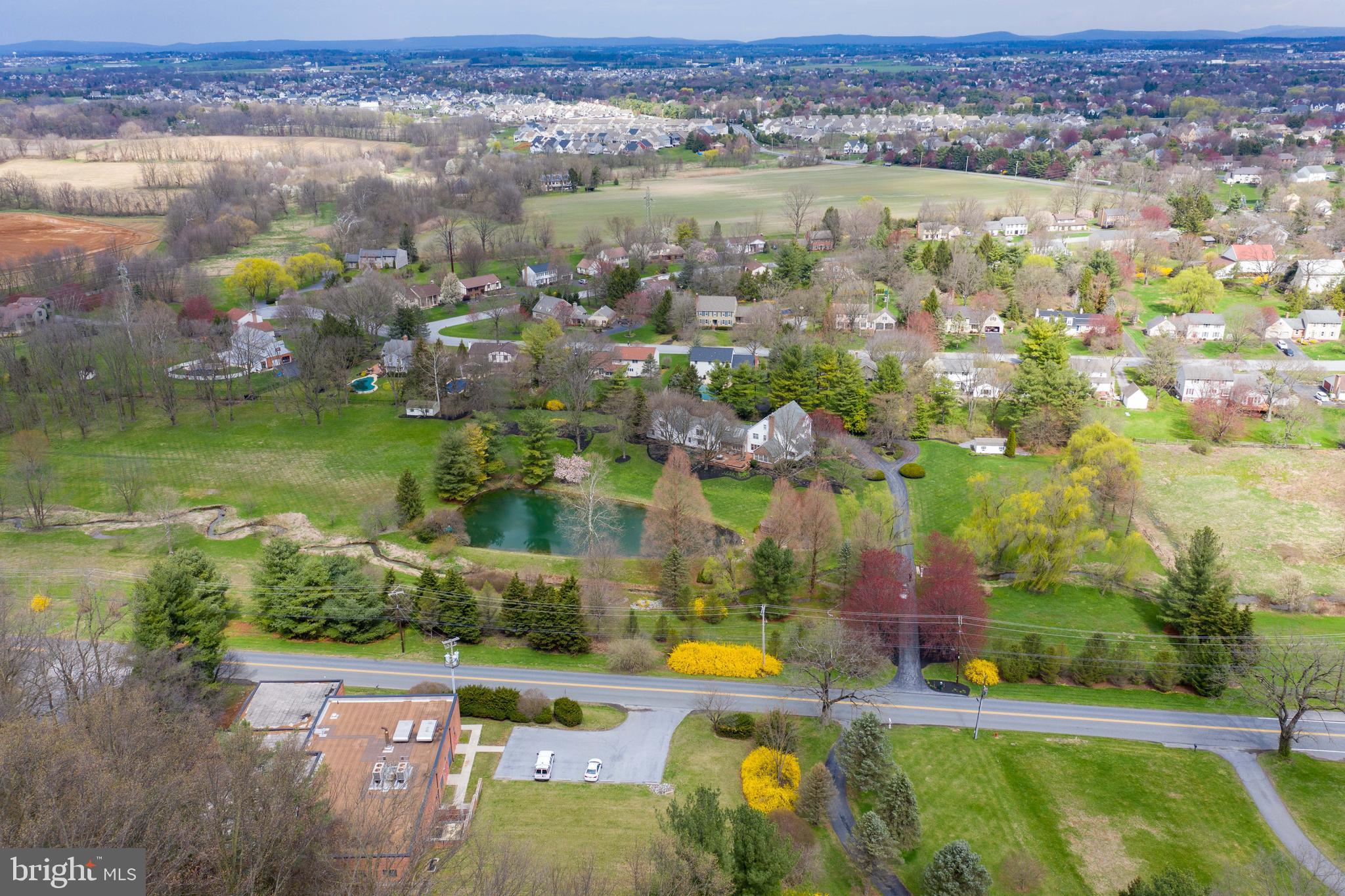 Ideally located in Manheim Township on a remarkable lot of over 13 acres stands this paradise of pure tranquility. Property is CLEAN AND GREEN leading to lower taxes. The driveway leads to an eye-catching, two-story Colonial featuring four bedrooms, two full and two half baths, and over 5,300 square feet of living space. The wonderful home has been extensively updated and improved with a new roof, new paint on the interior, and new carpet on the upper level. Additionally, refinished flooring, a remodeled and waterproofed lower level, and lots of pristine landscaping, make this property move-in ready and low maintenance. The formal dining room is lovely with crown molding and chair rails. A spacious family room shines with a wood burning fireplace and built-in storage. Everyone will congregate in the fabulous kitchen with oversized center island, stainless steel appliances, and lots of counter and cabinet space. The sunroom is a cozy place to read a book or relax while drinking a cup of coffee. A unique craft room comes complete with an island, vaulted ceiling and skylights. The upper level hosts spacious bedrooms and baths. The finished lower level has plenty of room for TV and games, plus additional storage. If you need an area for a quiet office, the lower level offers that as well. With a separate entrance from the main home and offering privacy is a finished living area above one of the detached garages that includes a great room, living room or bedroom, and a full bath. This is a perfect area for a family or guest suite or even a place where a nanny could stay. The exterior of the property is a masterpiece with a gorgeous pond overlooked by a gazebo and oversized brick patio that has scenic views and is a fantastic place for entertaining or summer gatherings. Excellent location close to Ciro's Italian Bistro, Mad Chef Craft Brewing, Bent Creek Country Club, as well as Lititz, Lancaster, and Manheim Township School District. This is a one-of-kind gem that you won't want to miss!