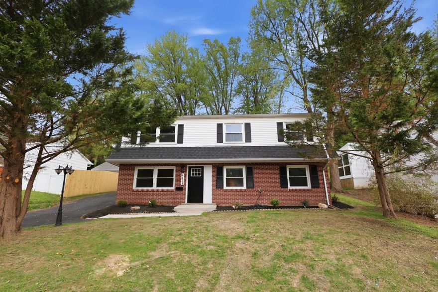 Fully remodeled 4 bed, 2 full bath single family home with a rear sunroom. New roof, new water heater, new electrical panel, new washer/dryer, new front door, new exterior stairs, new flooring on the lower level & refinished hardwood floors on the main level, fresh paint, and new tiered landscaping out back. Lower level has a living room, a large bedroom and custom walk-in closet, full bathroom with walk-in shower, and storage/utility room. Main level has a living room, dining room, open kitchen, sunroom, three bedrooms, and a renovated bathroom with double vanities and shower/tub. Remodeled kitchen has white shaker cabinets, quartz countertops, stainless steel appliances, and a built-in microwave. Property has pull-down stairs to the attic and a long driveway with space for 3-4 cars. Private backyard backs to trees.