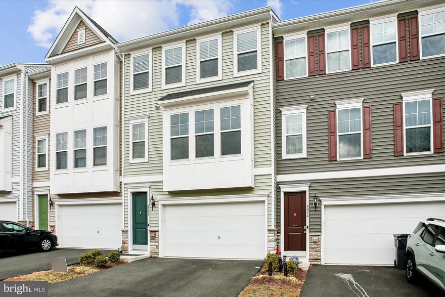 This beautifully upgraded townhome features luxury vinyl plank flooring throughout the main level and a gourmet kitchen complete with stainless-steel appliances, a large island with bar seating, and stylish pendant lighting. Enjoy easy access to the back deck off the kitchen—perfect for entertaining. The spacious family room and convenient powder room complete the main level. Upstairs, you’ll find three generously sized bedrooms, including a serene primary suite with an ensuite bath offering dual vanities, a water closet, and a glass-enclosed shower. Two additional bedrooms share a well-appointed hallway bath, and full-size laundry is included. The lower level boasts a versatile recreation room with an additional half bath. A two-car garage with driveway parking and a fenced-in backyard round out this exceptional home. Conveniently located near I-95 and Quantico Base, offering easy access for commuting and travel.