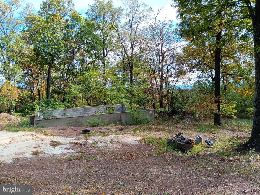 Great 1.06 Acre lot in Sleepy Hollow with a 24'x32' foundation already built and a septic system installed. Beautiful winter views of the valley and mountains, remove a few trees and enjoy the view year around! This lot is in the Morgan County section of Sleepy Hollow. Community features include a lake with a beach and dock area, a picnic and baseball/softball area, and multiple access points to Sleepy Creek Wildlife Managment area for all your hiking, hunting, and other recreational activities.