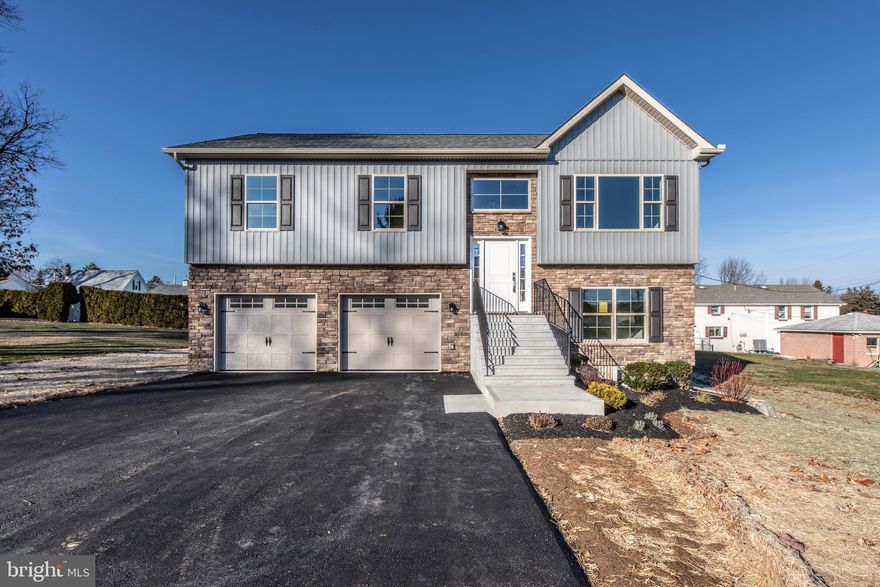 NEW extra sharp Bethlehem Township Bi-level packed with amenities and features. Modern open floor plan with cathedral ceiling encompassing the entire main living area. Custom kitchen island with granite counters, tile backsplash and stainless-steel appliances is adjacent to the open dining and living room providing a great entertainment space. 3 bedrooms and 2 full baths, including the primary suite with trayed ceilings complete the main floor. All rooms, except baths on main level have gorgeous hardwood floors. All bathrooms have ceramic tile floors with granite tops. The lower level has luxury vinyl plank throughout and offers a family room with an ecofriendly electric fireplace, wet bar, a 4th bedroom and 3rd full bath creating perfect extended family living. The maintenance free deck off the dining room or the huge concrete patio off the lower-level family room provide a relaxing space while you enjoy the outdoors and the easily managed rear yard. The 23x23 oversized garage with whisper quite door openers has an additional 6x8 storage area. This home is truly move in ready as builder has installed shower doors, window treatments and high-tech security/intercom system with four cameras and even a mailbox. Great walkable location yet easy access to all major routes and 33/78 interchange. This beautiful home is ready for immediate occupancy.