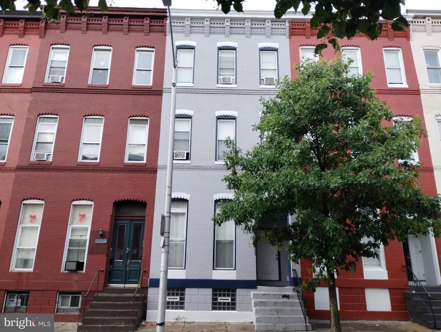 Here's your opportunity to live in a historic Baltimore home just minutes from downtown with all of its charm.  This first floor, one bedroom, one bath unit has high 11 foot ceilings.  The bedroom features floor to ceiling windows with interior shutters.  Open the shutters to fill the space with natural light.  This unit has an open floor plan.  The spacious kitchen has room to dine.  Wood floors are in the bedroom and living room.  Ceiling fans are throughout.