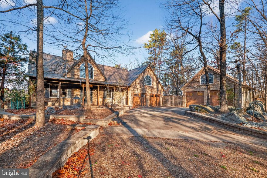 Your Mountain Retreat Awaits!
Experience the perfect blend of modern living and serene mountain charm in this beautiful contemporary home, ideally situated in the scenic hills of West Virginia—just 30 minutes from shopping, dining, and other amenities.
With over 3,000 square feet of living space, this home features hardwood flooring throughout, a stunning stone see-through fireplace in the family room/dining area, and a sleek, updated kitchen with a spacious island and gas stove.
The finished walk-out basement includes a full bedroom and bath, perfect for guests or extended stays. Upstairs, the luxurious owner’s suite offers a peaceful retreat, and an additional large room with a picturesque window provides flexible space for a bedroom, office, or studio.
Step outside to enjoy panoramic views from the expansive back deck or unwind on the inviting front porch. Additional outdoor features include a relaxing hot tub, a charming pond, and a fully fenced (electric) gated property for added peace of mind.
A detached, heated  bonus garage offers even more versatility, complete with a finished room above that can be used as a bedroom, office, or hobby space.
This home is equipped with a whole-house generator and multiple heating sources, ensuring year-round comfort and security.
Located in Ritters Hidden Valley, you’ll enjoy community amenities such as a sandy swimming lake, a stocked fishing lake, picnic pavilion, tennis courts, playground, and over 20 miles of trails for ATV or side-by-side riding. Hunting is also permitted within the community.
If you’re seeking a one-of-a-kind property that combines natural beauty, modern convenience, and adventure—this is the one!