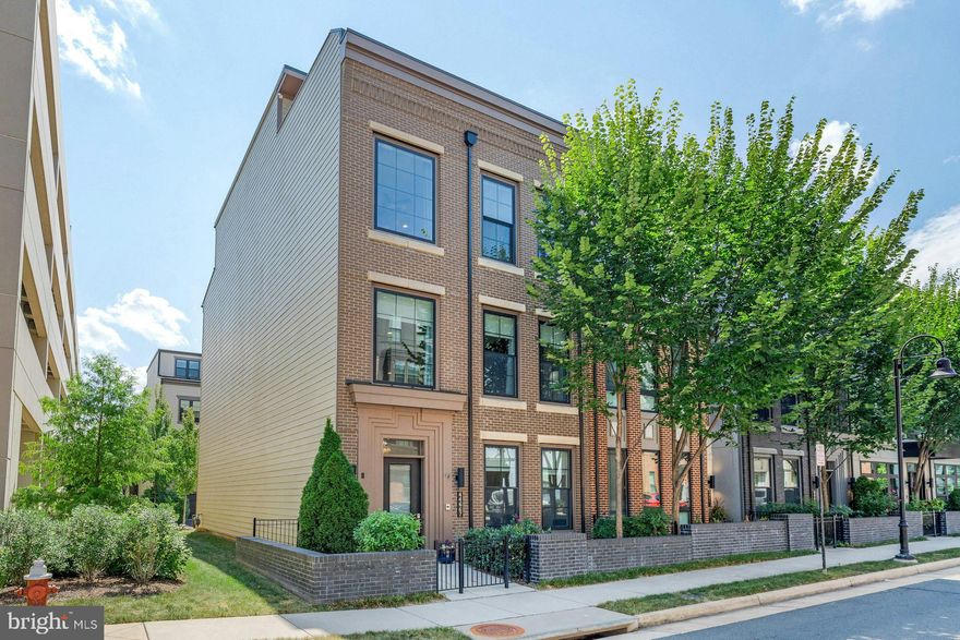 Experience sophisticated living in this four-story elevator townhouse offering over 4,300 square feet of modern design and luxurious finishes in Loudoun County’s premier urban enclave.The main level is designed for connection and celebration. With soaring ceilings and walls of windows, every gathering is bathed in natural light. At the heart of the home, the chef’s kitchen beckons with bespoke cabinetry, quartz countertops and backsplash, a four-seat island, and a full Subzero/Wolf appliance suite—including a tower wine fridge. Here, you’ll craft gourmet meals, linger over fine wines, and share memorable dinners with loved ones. The adjoining living area, with its sleek linear fireplace, sets the stage for evenings filled with warmth and conversation. Retreat to the owner’s suite, a private sanctuary complete with spa-inspired bath and expansive walk-in closet. Two additional bedrooms share the convenience of an upper-level laundry room, blending comfort and practicality. The fourth floor is an entertainer’s dream—an airy recreation room opening to a rooftop terrace perfect for sunset cocktails, starlit dining, or weekend brunches with friends. An additional bedroom and full bath on this level welcome overnight guests in style. On the entry level, a versatile flex space with full bath offers endless possibilities—whether as a refined home office, fitness studio, or private guest suite. With 10-foot ceilings on three levels and 9-foot ceilings on the terrace level, the home feels bright, open, and inviting at every turn. Smart features elevate the everyday, including a Control4 hub, five-zone built-in speaker system, Anderson black-framed windows, smart garage door, and dual high-efficiency HVAC systems. Best of all, this residence places you at the heart of One Loudoun—steps from fine dining, boutique shopping, weekend markets, fitness clubs, and entertainment venues. Whether hosting loved ones at home or enjoying the vibrancy of the community, this property offers a lifestyle without compromise.