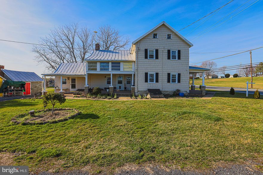 Rare opportunity to own a classic Carroll County farmstead now zoned Residential — offering the best of country living with the ease of residential financing! This charming 4-bedroom, 2-bath Farmhouse/National Folk-style home sits on 10.71 stunning acres featuring original hardwood floors, a cozy brick fireplace, and a durable metal roof. Updated bathrooms and fresh paint throughout make this truly move-in ready. The spacious eat-in kitchen includes stainless steel appliances. Step outside to find a classic red bank barn with multiple uses, two detached garages, multiple outbuildings, four fenced pastures, and a serene private pond tucked in a wooded setting — ideal for hobby farmers, horse lovers, or 4-H families. Conveniently located minutes from Route 140 and I-795 with shopping, schools, and employment all within 5 miles. No HOA. Properties with this combination of acreage, infrastructure, and residential zoning are extremely rare in Carroll County — don't miss this one!