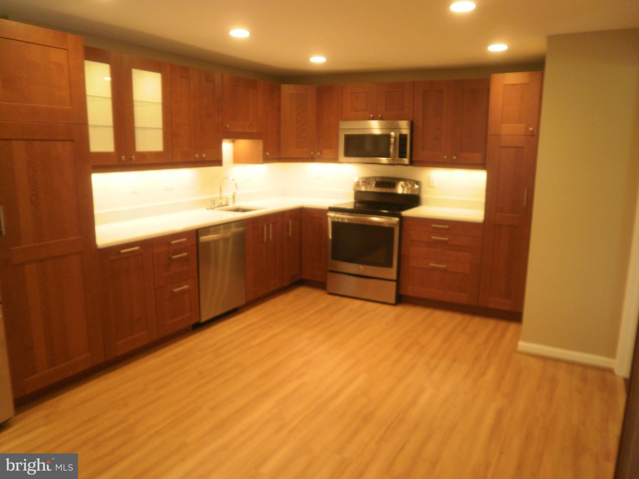 This gorgeous brick front Stedwick townhouse is almost 2000 finished square feet and updated from top to bottom. Welcoming entryway is light and bright and opens to the spacious living room. You will also find a convenient powder bath tucked away off the foyer. In the rear of the house you will find the formal dining room that features a sliding door to the rear deck., and then you will see the real star of the home...the kitchen! Recently updated with rich maple cabinets, quartz countertops and stainless appliances, this one is a chef's dream with plenty of countertop space, cabinets and pantry storage. Upstairs you will find two roomy secondary bedrooms and a hall bath, also updated with custom tile surround. The main upper level bedroom features a sitting area/study, large closet and en suite bathroom, complete with subway tile surround and white & chrome accents. On the lower level, you will find a finished rec room/family room, a large utility room with washer/dryer and tons of extra storage space. The lower level also walks out to a delightful patio space and fenced yard. The neighborhood is super convenient to area schools - Stedwick Elementary, Montgomery Village Middle School & Watkins Mill High School. Walk to The Heights Tennis Courts, Watkins Mill Recreation Area and the Stedwick Mill Community Center. Grocery shopping and restaurants all within a few miles. Easy access to Hwy 270 with the new Exit 12 and other commuter routes - bus stop is less than a mile away! Please use online application for your convenience!