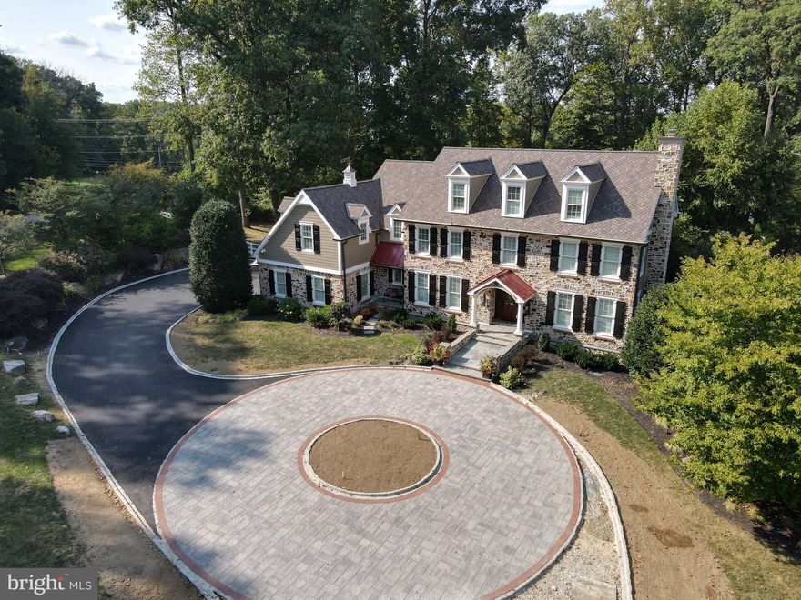 Located in the heart of Charlestown Township, this beautiful Chester County style farmhouse has nearly 8,000 square feet of finished space from the basement to the 3rd floor. This five bedroom plus bonus in law/au pair suite with 5 full bathrooms and 3 halves, is one of the finest stucco remediation renovations I have ever seen.  House was taken down to the studs, insulated with new Rockwood insulation, then replaced with Chester County fieldstone and James Hardie siding (all four elevations incorporate design elements of stone, colonial red standing seam porch roofs, deluxe AZEK window/door trim, and James Hardie siding). There is a new 50-year Certain Teed roof with all copper valleys/step flashings. All work was overseen by an independent third-party inspector. Warranties transfer. The natural gas heated salt water pool was installed in 2023 and features a waterfall, grotto, 6 LED lights, sun deck, and in pool seating.  There is extensive hardscaping/landscaping and landscape lighting throughout the entire property!  A whole house Cummins 30Kw generator powers the entire property (upgraded PECO gas line delivers up to 1,000,000 btus if needed for the generator/pool heater). The backyard is your own private oasis with hot tub, koi pond with stream and several large flagstone patio areas.  As you pull down the private cul-de-sac, you are greeted by a brand-new circular paver driveway with Belgium block curbing and apron, which adds to the sophistication and class that this mature nearly 2-acre private property exudes. Upon entering this home, you walk up a beautiful flagstone walkway and through a custom sapele wood front door with true beveled glass. There is a sophisticated security camera system (9 HD/night vision security cameras cover the perimeter of home). It is one of the smartest homes you could ask for: apps on your phone or tablet control Hikvision security camera system, Hydrawise irrigation, iAqua link pool, Lennox iComfort HVAC, Russound/Sonos audio system (6 zones on 3 floors plus outdoor Bose speakers).  All of the details on these systems are located in the document section.  As you enter the home, you will notice the openness and flow with hardwood, 9’ ceilings, family room with raised hearth fireplace and an amazing custom large window overlooking the backyard/pool (it is one of the biggest windows made by Pella!). Continuing on the main floor is the gourmet kitchen with stone wall, plenty of cabinet space, quartz countertops, large island, ship-lap ceilings w/two skylights, two pantries (one is walk-in), and mudroom off the garage with six cubbies.  Powder room, laundry room, and garage access are right off the kitchen.  This floor also boasts a unique square shaped formal dining room, formal living room with gas fireplace, large office space with interior french-glass doors with lots of cherry built-ins and a second half bath. The fully finished basement has media area, wet bar with beautiful wood built-ins, gym, in-law/au pair suite with full bathroom, as well as a separate half bath.  There are multiple storage areas and the walkout door and adjacent windows let in lots of natural light.  On the second floor, the primary bedroom is quite spacious with tray ceilings, a separate large sitting room, walk-in closet, large bathroom with jetted tub, stall shower and double sinks. Hardwood floors go throughout the second floor.  There is a princess suite with private bath and large closet, two additional bedrooms that share a Jack and Jill bath, an additional laundry room with extra large washer and dryer, and large bonus/hangout room over the garage.  But wait, that’s not all!  There is a fully finished attic/3rd floor with hardwood floors, huge bedroom, full bath, living area, and a walk-in cedar closet.  ZERO wall to wall carpeting, hardwood/tile on all four levels and a new epoxy garage floor.  In the award winning Great Valley School District.