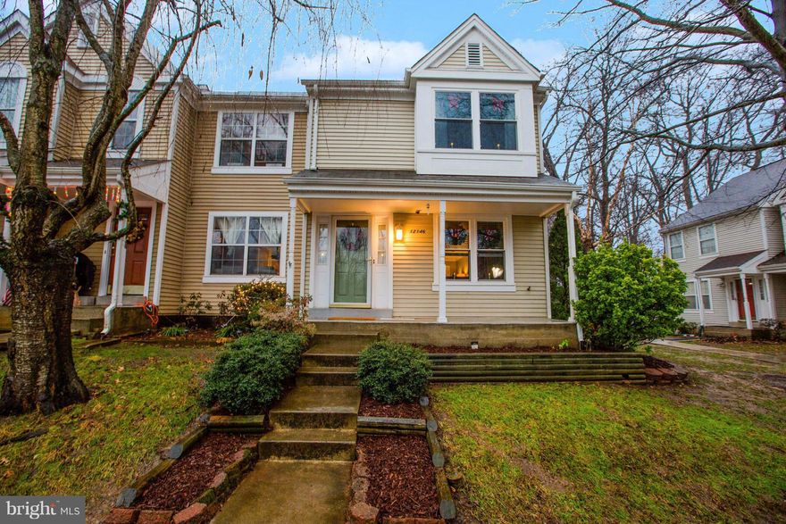 HELLO PERFECTION! Stunning, rarely avail, end unit w/ lovely front porch & lake views. Ultra functional, modern flpn, pass thru kit, drama  bay windows; open din rm , fireplace LR, all white kit w/ silestone counters, fabulous wood floors, private flagstone patio, br new carpet up & down; incredible master suite + 2 big bdrms up, fully fin LL w/ recessed lighting