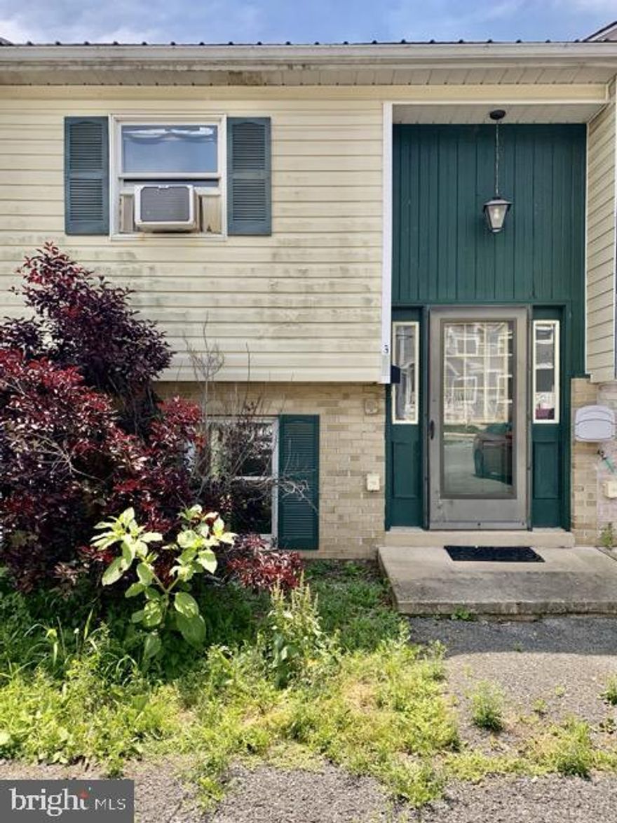 Investment opportunity with this 2BR 1.5BA townhome. Needs work and sold as is where is. Main level living room, kitchen with dining area, half bath (needs completed). Spacious rear yard.