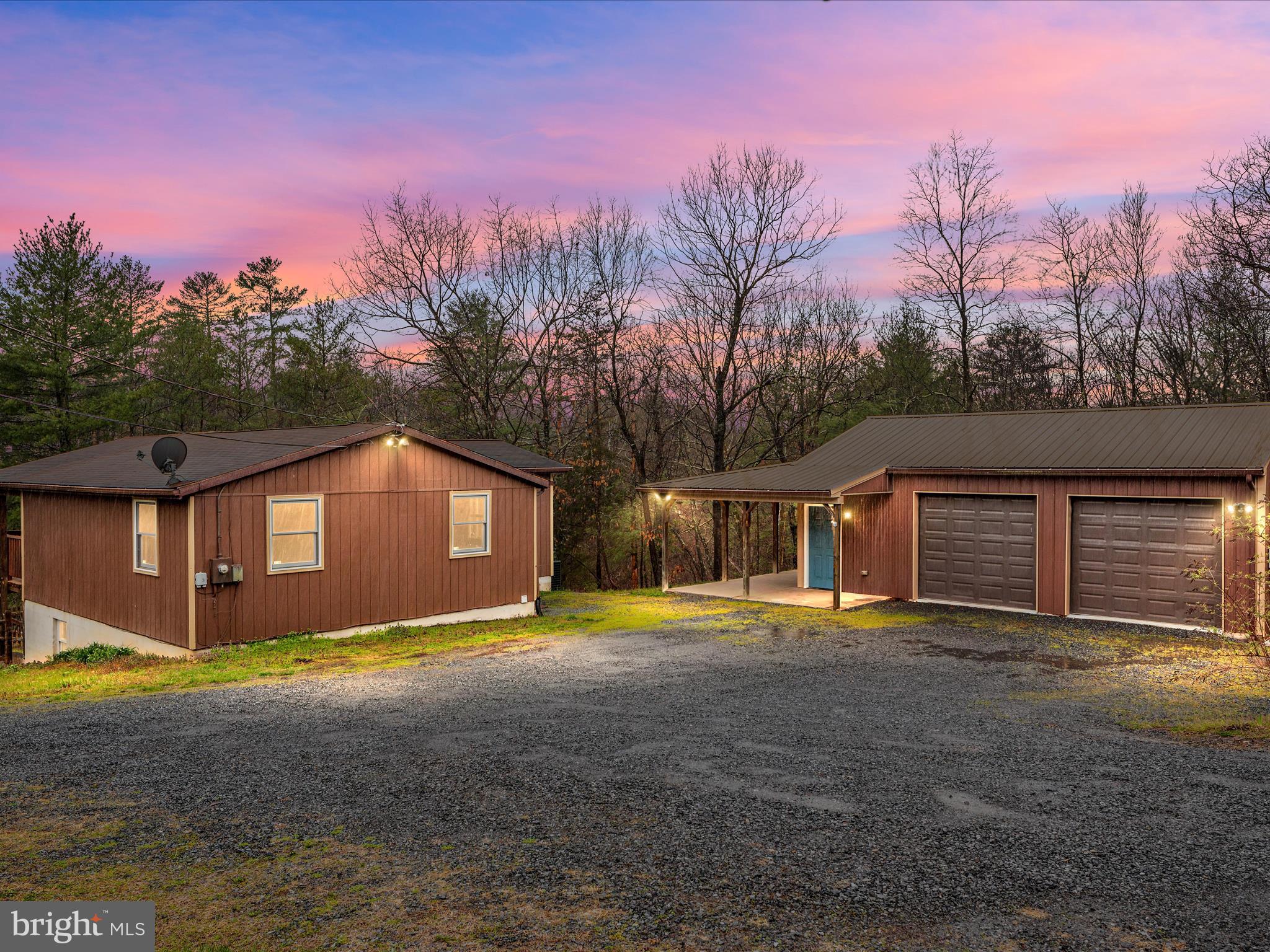 Escape to the peace and tranquility of this rustic lakefront cabin in Cherry Run! Nestled on 1.89 acres, this property offers a serene, wooded setting that feels like a private retreat.
Featuring 3 bedrooms and 2 baths with a family room that opens to a huge covered porch overlooking the lake. Two bedrooms are conveniently located on the main level, while the basement boasts a primary suite complete with a full bathroom and a spacious walk-in closet. The basement also provides flexible space for an office, hobby room, or workout area.
The home is equipped with a newer HVAC system installed in 2023, ensuring comfort throughout the seasons.
Step outside to enjoy breathtaking views of the lake, perfect for fishing and canoeing. The fenced backyard and lower patio area offer a picturesque setting for relaxing or outdoor gatherings.
Additional highlights include a detached garage(24x32) with a metal roof and a separate electric panel.
Perfect for a workshop!
Whether you're seeking a weekend getaway or a permanent residence, this cabin offers the perfect blend of comfort and convenience. Located near The Woods Resort, you'll have easy access to a variety of outdoor activities and amenities. Schedule your showing today!