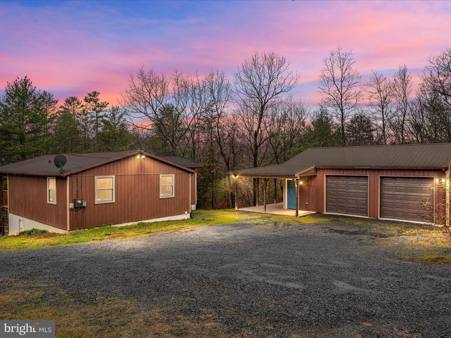 Escape to the peace and tranquility of this rustic lakefront cabin in Cherry Run! Nestled on 1.89 acres, this property offers a serene, wooded setting that feels like a private retreat.
Featuring 3 bedrooms and 2 baths with a family room that opens to a huge covered porch overlooking the lake. Two bedrooms are conveniently located on the main level, while the basement boasts a primary suite complete with a full bathroom and a spacious walk-in closet. The basement also provides flexible space for an office, hobby room, or workout area.
The home is equipped with a newer HVAC system installed in 2023, ensuring comfort throughout the seasons.
Step outside to enjoy breathtaking views of the lake, perfect for fishing and canoeing. The fenced backyard and lower patio area offer a picturesque setting for relaxing or outdoor gatherings.

Additional highlights include a detached garage(24x32) with a metal roof and a separate electric panel. 
Perfect for a workshop!

Whether you're seeking a weekend getaway or a permanent residence, this cabin offers the perfect blend of comfort and convenience. Located near The Woods Resort, you'll have easy access to a variety of outdoor activities and amenities. Schedule your showing today!