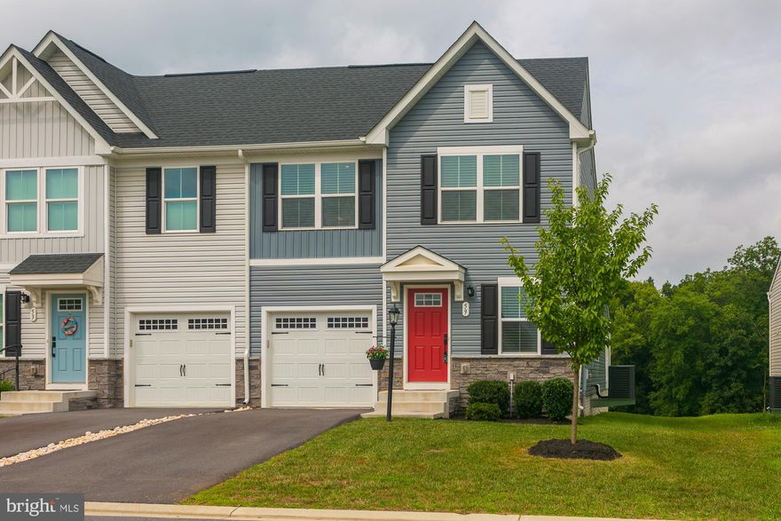 Bright and airy, this beautifully maintained townhome villa offers comfort, style, and functionality in every corner. The main level features luxury vinyl plank flooring throughout, a cozy living room with a warm electric fireplace, and a stunning gourmet kitchen complete with a large island with breakfast bar, granite countertops, and sleek stainless steel appliances. The main level also boasts a private primary suite with a tiled shower, double vanity, and generous walk-in closet. Upstairs, you'll find two additional bedrooms, each with their own walk-in closet, providing ample sleeping space or room for a home office. A full unfinished basement with bath rough-in offers exceptional storage or potential for future expansion. Off the kitchen, step outside to a covered rear deck that overlooks peaceful community greenspace and mature trees - perfect for relaxing or entertaining. This home combines modern finishes with a serene setting, making it a truly exceptional place to call home.