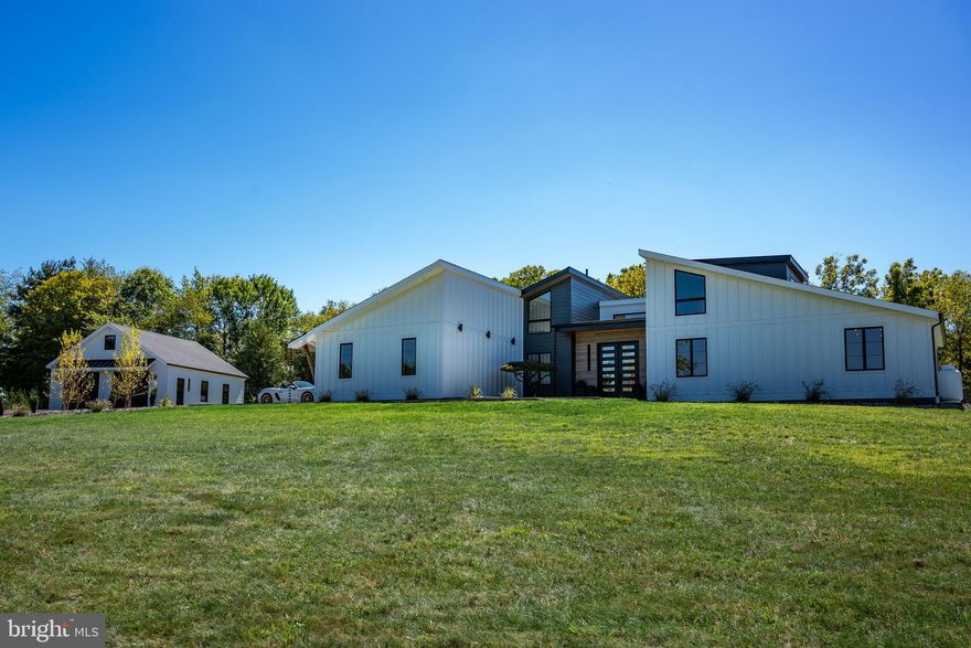 Discover modern sophistication at 77 Frankenfield Road, a newly renovated contemporary residence tucked away in the rolling countryside of Ottsville, Pa. Designed with a seamless blend of style and function, this home offers an elevated living experience in a serene Bucks County setting.
Inside, soaring ceilings create a sense of space and light, with expansive windows framing views of the surrounding landscape. The custom-renovated kitchen and living areas flow effortlessly, offering the ideal environment for both intimate evenings and lively gatherings. Every detail has been thoughtfully reimagined to balance clean, modern design with warm, livable comfort.
Step outside to your own private resort-style retreat. An inviting outdoor pool and lounge area transform warm-weather days into a luxurious escape, while the peaceful grounds provide the perfect backdrop for relaxation or entertaining under the stars.