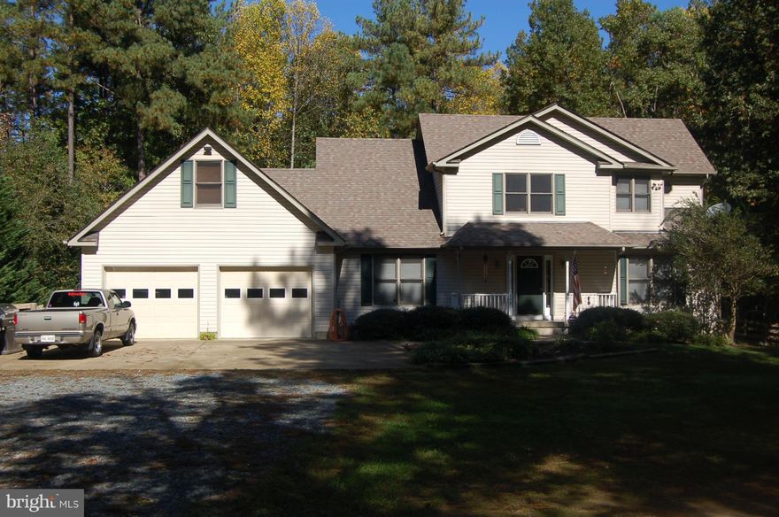 Wow, enter into a great open floor plan with big stone fireplace. Wood floors on most of main level & basement. 2 main level bedrooms. Master with balcony overlooking to woods, and jetted tub in bath. 2 bedrooms and full bath in basement, plus recreation and family rooms. Don't miss the loft/studio above oversize garage. New a/c. 2 water heaters, 1 gas, 1 electric. Beautiful lot and backyard.