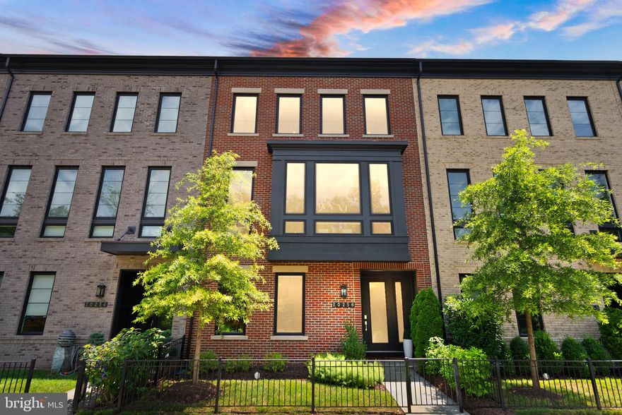 Welcome to this exceptional Miller & Smith 24’ wide luxury Uptown model townhome with bay window extension with front views of the wooded Central Park and an expansive rear terrace overlooking the open common area. This beautiful home is ideally located in the heart of One Loudoun and offering approximately 3,300 sq. ft. of upgraded living space with designer upgraded wide plank engineered wood flooring throughout. Only four-plus years young, this rare and spacious townhome features 4 bedrooms, 4.5 baths, and an array of high-end finishes and thoughtful upgrades throughout.

Once through the front door you are greeted by an inviting foyer with a custom glass light fixture. The entry level offers flexibility and functionality with a large office/optional 4th bedroom, full en-suite bath and custom built-in shelving & storage in the closet. This level is accessible to the finished 2-car garage with epoxy flooring and ample storage. Enjoy a designer stair system with upgraded handrails and modern balusters on all three floors. Windows throughout the home are appointed with smart, custom motorized blinds.

The main level is an entertainer’s dream, featuring a bright and open living space with soaring 10’ ceilings, an upgraded gas fireplace with custom tile surround and access to a spacious covered terrace with a retractable screen and oversized ceiling fan—creating a seamless indoor-outdoor living area.

The gourmet kitchen is a true centerpiece, offering an extended quartz island, professional-grade 6-burner gas stove with range hood, GE Café stainless steel appliances including 2 ovens, microwave, dishwasher and French Door refrigerator. Upgraded cabinetry, including a custom-finished pantry, designer tile backsplash, and a dedicated drop zone with built-in beverage cooler round out this amazing kitchen. A large dining space with modern custom light fixture and powder room complete this level.

Upstairs, the owner’s suite is a private retreat, highlighted by a ceiling fan, expansive custom walk-in closet, and a luxurious en-suite bath featuring a frameless shower with rain head & hydrorail column, soaking tub and gorgeous designer tile. Two additional upper-level bedrooms—one with its own en-suite bath and the other with access to a full hall bath—provide ample space for family or guests. The laundry room, with custom cabinetry is conveniently located on the upper level as well.

Facing a fully-wooded view and immediate access to One Loudoun’s beautiful Central Park (a peaceful oasis of natural beauty, offering amenities like walking trails, a playground, and open fields) and backing to a landscaped community green space with firepit and gathering area, this home offers both scenic views and a vibrant lifestyle. Finished, rear-accessed 2-car garage & driveway along with ample Northpark Drive street parking allows for easy guest parking. Living in One Loudoun means walking access to award-winning amenities: a private clubhouse, pool, tennis and pickleball courts, trails, playgrounds, an outdoor amphitheater, and more.

All of this just steps away from Downtown One Loudoun’s dynamic mix of restaurants (Matchbox, Uncle Julio’s, Sense of Thai), shops (lululemon, Scout & Molly’s, Trader Joe’s), entertainment (Alamo Drafthouse Cinema), corporate hubs…and so much more on the way including Arhaus, Williams Sonoma, Pottery Barn, bartaco & more. Plus, enjoy quick access to Route 7, Loudoun County Parkway, Dulles Airport, the Silver Line Metro and Washington, D.C.

Luxury, location and lifestyle—this spacious home truly has it all!

NOTE: OWNER IS REALTOR.