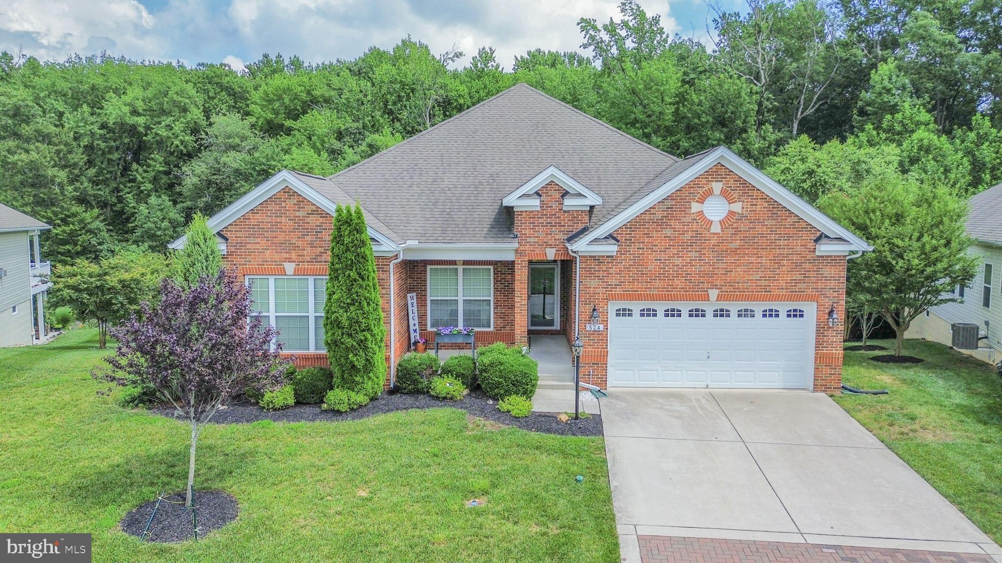 Rarely available and impeccably maintained, this stunning brick front rancher in the prestigious Bulle Rock community offers the perfect blend of luxury, functionality, and versatility. Boasting a main-level in-law suite with a private entrance, this home is ideal for multi-generational living or accommodating guests with ease.
Step inside to find exquisite engineered hardwood floors and 9 foot ceilings flowing throughout the main level. A gracious foyer with custom wall molding leads to the formal dining room and seamlessly transitions into the heart of the home—a gourmet eat-in kitchen featuring stainless steel appliances, recessed lighting, granite countertops, tile backsplash, a walk-in pantry, and an oversized island with breakfast bar seating for 4–5. The open-concept family room invites relaxation with a ceiling fan and cozy gas fireplace, while the adjacent screened-in rear deck offers tranquil views of mature trees—perfect for morning coffee or evening gatherings.
The main level also includes a spacious primary suite with tray ceiling, crown molding, ceiling fan, dual walk-in closets, and a luxurious en suite bathroom showcasing a jetted soaking tub, separate shower, and dual vanities. Two additional generously sized bedrooms, a full hall bath, a well-equipped laundry room, and a 2-car attached garage complete the main level.
The fully finished lower level is nothing short of expansive, offering two 20x25 game/recreation rooms with carpet flooring and recessed lighting, a full bathroom, and multiple storage and utility spaces—one of which offers potential for an additional bedroom or hobby room.
Unique to this home is the fully integrated main-level in-law suite, accessible via a private entrance off the covered front porch or through the main house. This beautifully designed suite features its own living area with barn door accent, ceiling fan, recessed lighting, engineered hardwood floors, and a kitchenette with granite countertops, fridge, and microwave. The suite is complete with a spacious bedroom and a full bathroom with ceramic tile surround and shower bench.
This exceptional home in sought-after Bulle Rock truly has it all—modern design, thoughtful layout, flexible living options, and countless amenities that Bulle Rock has to offer, pools, tennis courts, a clubhouse, and so much more—all nestled on a serene, wooded lot. Welcome home!
**Property also features 17kw Generac generator and leaf guard