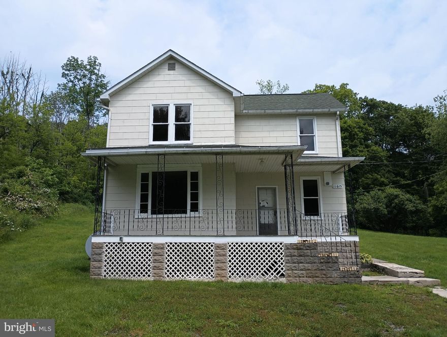 3BR/1BA Farmhouse-style home, situated on a 0.3-acre lot with front porch.