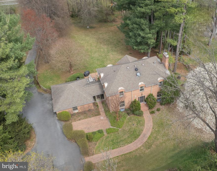 Welcome to 1803 Thornton Ridge Rd – a beautifully updated all brick custom built home in Ruxton/Riderwood,  one of Towson's most sought-after neighborhoods. Blue Ribbon Riderwood Elementary School zone, only a 5 minute walk from home! In addition to offering the top ranked public schools in Baltimore County, this spacious 5-bedroom, 4.5-bathroom residence offers over 3,000 square feet of refined recently fully renovated and updated living space, blending timeless charm with high-end modern upgrades.
From the moment you arrive, the curb appeal shines with mature landscaping and a classic front porch and patio. Inside, you'll be greeted by refinished hardwood floors on the main and upper levels, abundant natural light and a warm, open layout perfect for both everyday living and entertaining.
Floor to ceiling custom Pella windows drench the open, spacious, flowing main level with natural light all times of day. Recent improvements have transformed this dream home into the absolute perfect, low maintenance family home. 
At the heart of the home is a stunning, fully renovated kitchen featuring quartz countertops, a new farmhouse sink, built in retractable microwave, oversized center island, stainless steel appliances, and custom cabinetry. It flows effortlessly into a spacious family room with fireplace and adjacent formal living and dining spaces.
Recent upgrades include a second HVAC unit for true two-zone climate control, updated electrical system, and LED lighting throughout for energy efficiency and comfort. Ceiling fans in the 4 upper level bedrooms, completely new primary suite full bath, plus 3 more fully renovated full baths plus fully renovated 1/2 bath on main level. New attic fan installed for additional climate control. The newly fully finished lower level with antimicrobial waterproof, scratchproof flooring adds flexible space for recreation, a home office, gym, and guest suite with walk up to rear patio.  Also in lower level is a Built in workshop and storage area.
Upstairs, the spacious primary suite offers a walk-in closet, 2 large additional closets, a luxurious new en-suite bath, while three additional bedrooms provide plenty of room for family, guests, or work-from-home needs. Outside, enjoy a private backyard oasis with a new dog-safe split rail fence around the perimeter (private 1+ acre fenced yard), perfect for pets and play, plus a large rear and front patio ideal for entertaining or relaxing.
Pull down stairs to full attic offer abundance of storage space.
Set back on its own private oasis, but still a football's throw away from all the conveniences you so desire. 1803 Thornton Ridge Rd offers the perfect balance of style, function, and location. This move-in ready fully renovated home is a rare find—don’t miss it!