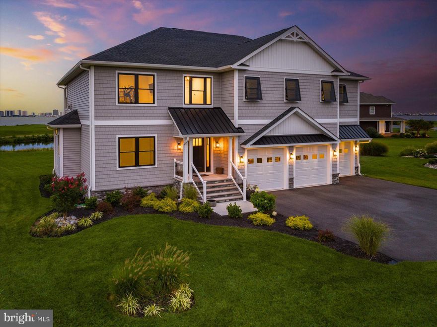 Welcome to this coastal paradise in Bishopville, Maryland! Nestled in the serene Light House Sound golf-course community, this 1-year-old home exudes elegance and charm. Boasting 5 bedrooms and 3.5 bathrooms spread across almost 4,000 sq ft, it offers ample space for your family and guests.

Step inside, and you'll be greeted with an abundance of natural light and sweeping views of Assawoman Bay and the Ocean City skyline, creating an airy and inviting ambiance. The reverse floor plan enhances the open living space and maximizes the views, with the kitchen, living room, dining area, primary bedroom and a guest bedroom conveniently located on the second floor. Three additional bedrooms and central living area on the bottom floor provide a private retreat for everyone.

The heart of this home is the gorgeous coastal style chef's kitchen. Luxurious, functional and visually striking, it’s equipped with top-of-the-line stainless steel appliances and elegant quartz countertops. The centerpiece is the large island, perfect for meal prep, casual dining, or gathering with loved ones. 

Each of the oversized bedrooms was designed with comfort in mind, allowing you to unwind and relax in your personal haven. The craftsmanship of this home is exceptional. Crafted by the renowned Iacchetta Builders, every detail is exquisite. The thoughtful craftsmanship is evident in every corner, showcasing attention to detail and a commitment to quality.

The framed elevator shaft gives you the option to add an elevator, enhancing accessibility. The 3-car garage provides ample space for your vehicles and storage needs, ensuring convenience and organization.

One of the highlights of this property is the breathtaking golf course views that overlook Assawoman Bay, providing a sense of tranquility as you soak in the picturesque skyline of Ocean City, MD. Enjoy the best of coastal living on the screened porch or elevated deck, perfect for relaxation and entertaining.

Surrounded by a spacious yard, you have plenty of room for outdoor activities and potential landscaping projects. Plus, being just minutes away from the sun-kissed beaches of Ocean City, MD, you'll have an endless array of leisure options and beachside fun.

This coastal gem presents an opportunity to experience the best of coastal living, with nearby beaches just minutes away. Embrace the tranquil and laid-back lifestyle, and make unforgettable memories in this coastal haven.

Don't miss the opportunity to call this exceptional home yours—a perfect blend of luxury, comfort, and coastal charm. Come and experience the serenity and splendor that Light House Sound in Bishopville, MD, has to offer.