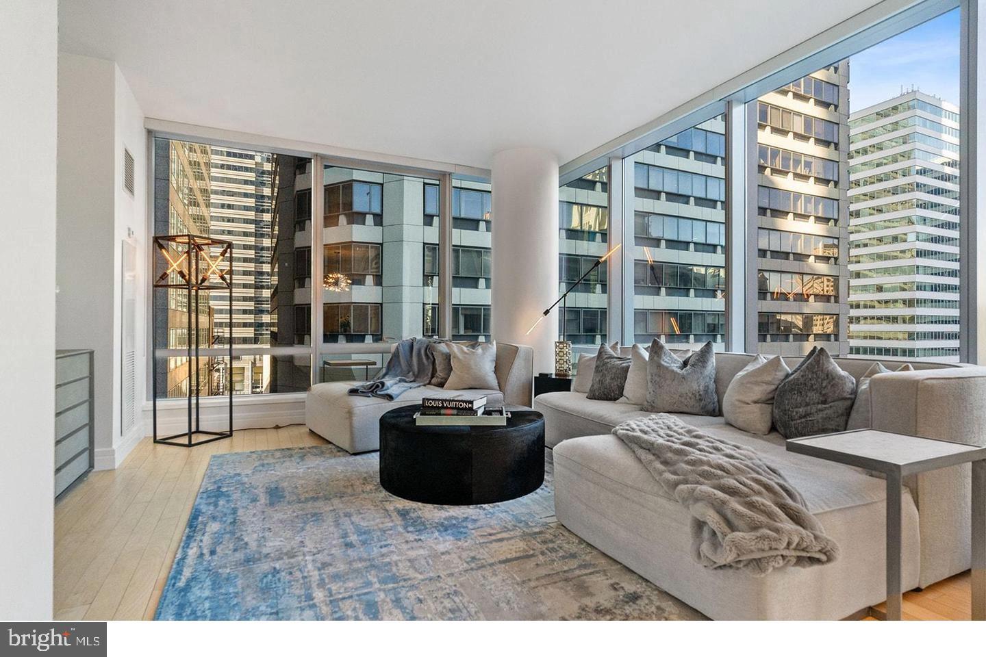 Enjoy five-star living in this exquisitely renovated 2-bedroom, 2.5-bath corner residence at The Ritz-Carlton Residences, offering the most desirable floor plan with sweeping views of Dilworth Plaza and City Hall. This exceptional unit includes one-car garage parking and showcases timeless elegance with refinished Brazilian cherry hardwood floors, motorized window treatments, smart lighting controls, and designer fixtures throughout. The entryway welcomes you with a gallery-style hall perfect for displaying artwork, leading into the expansive living and dining areas, which are framed by floor-to-ceiling windows that bathe the space in natural light and highlight the dramatic cityscape beyond.
The renovated gourmet kitchen is a chef’s dream, featuring a waterfall-edge quartz island, marble flooring and backsplash, Sub-Zero refrigerator, Viking range and microwave, Miele dishwasher, U-Line wine cooler, and a Franke undermount sink. The spacious primary suite offers two custom closets and stunning skyline views, while the luxurious en-suite bath boasts Calacatta marble floors and counters, dual vanities, a Bain ultra-soaking tub, Duravit commode, and a frameless glass steam shower. The guest suite includes its own custom closet and a stylish bath with Calacatta Gold marble, pedestal sink, and frameless shower door. A marble-appointed powder room completes the home’s refined layout.
Living at The Ritz-Carlton Residences means enjoying an unmatched level of service and amenities, including a 24-hour concierge and doorman, chauffeur-driven Mercedes and covered resident access to the Ritz-Carlton Hotel, where you can enjoy in-room dining and discounted rates at luxury Marriott properties worldwide. The building’s recently reimagined common spaces include a 7,000-square-foot state-of-the-art fitness center with an indoor lap pool, hot tub, and yoga/Pilates room; a newly updated residents’ lounge with a balcony, caterer’s kitchen, and media room; and a serene private outdoor park with a waterfall and gated dog area. Additional services such as pet walking, babysitting, dry cleaning, and storage units are available for an additional fee.
Perfectly situated in the Rittenhouse Square and Avenue of the Arts neighborhood, this unparalleled home places you steps from Philadelphia’s finest dining, shopping, arts, culture, hospitals, and public transportation. Experience elevated urban living in a residence that reflects the world-class luxury and legendary service of The Ritz-Carlton.