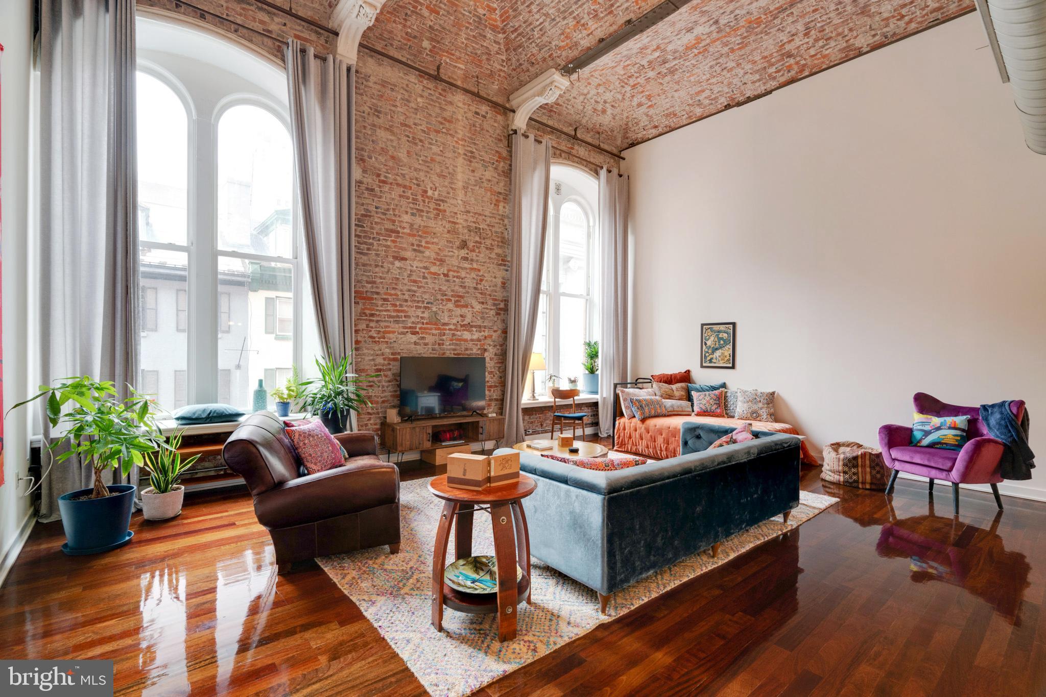 Welcome to Unit 205 at the White Building, where historic charm meets modern luxury in this exceptional urban loft. Boasting soaring 22-foot ceilings and two oversized windows, this 1-bedroom, 2-bathroom condo offers a truly extraordinary living space. Every corner of this home reflects a perfect blend of classic character and contemporary elegance, with original exposed brick and expansive white walls creating an art lover's paradise.
Spanning 1,334 square feet, this thoughtfully designed residence features high-quality finishes that showcase refined craftsmanship and timeless style. The spacious layout provides ample room for both entertaining and daily living, with abundant storage and pantry cabinetry ideal for those who love to host or stay organized. The space is large enough to create a separate, secondary bedroom area without taking away from the spaciousness, offering flexibility to suit your needs.
Designed for modern living, this condo includes an in-unit washer and dryer, front door security, access to a private fitness center, a mail/package room, and convenient elevator access. Located in the vibrant Midtown area, you'll be above an impressive selection of top-tier restaurants like El Vez, Sampan, Barbuzzo, Lolita, Little Nona’s, Charlie Was A Sinner, Fergie's Pub, Alpin Rose, and many more, offering endless dining and entertainment options right at your doorstep.
Originally built in 1867 as the SS White Dental Manufacturing Company’s factory space, this boutique building is surrounded by dynamic new developments, including over one billion dollars of investment within two blocks. With low condo fees and the option to rent parking at nearby garages, convenience is guaranteed.