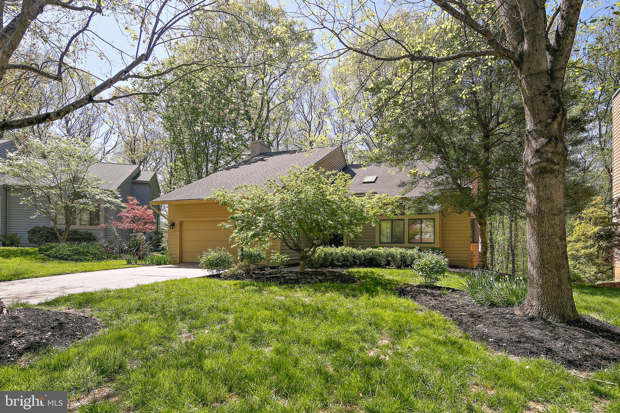 OFFER DEADLINE: SATURDAY, MAY 3RD AT 2 PM.
Nestled in a quiet cul-de-sac in Hickory Ridge, this cozy contemporary offers a perfect blend of warmth, style, and serenity. Surrounded by trees and bathed in soft, natural light, the home welcomes you with vaulted ceilings, skylights, and an airy foyer that sets the tone for the whole house. The spacious living room shares that stunning ceiling height and includes custom window treatments, while the dining room opens to the back deck—ideal for outdoor dining or simply soaking in the view. The kitchen is both beautiful and functional, with white shaker cabinets, granite counters, stainless steel appliances, a custom tile backsplash, and a built-in nook for your coffee bar or home workstation. There’s also seating at the island and a cozy breakfast area with deck access. The family room is connected to the kitchen and is a great space for relaxing after a long day. A mudroom with custom built-ins sits just off the two-car garage and the attic over the garage is built out for extra storage. The deck extends the length of the home and even has a sunken hot tub (bonus: the seller has worked with an amazing hot tub company that has maintained the hot tub for many years). Upstairs, the light-filled landing leads to three bedrooms and two full baths. The oversized primary suite features a cathedral ceiling, a walk-in closet with custom storage, and a gorgeous spa-like bath with a soaking tub, glass-enclosed shower, and double vanity. The updated hall bath has a skylight and both secondary bedrooms are bright and spacious. The lower level offers flexible space for work, play, or guests, with a fourth bedroom, full bath, rec room with built-in desk and shelving, laundry room, and walk-out access to the backyard. Whether you're enjoying the peaceful wooded views, entertaining on the deck, or working on a new hobby in the garage, this home brings comfort and calm to everyday living. Welcome home!