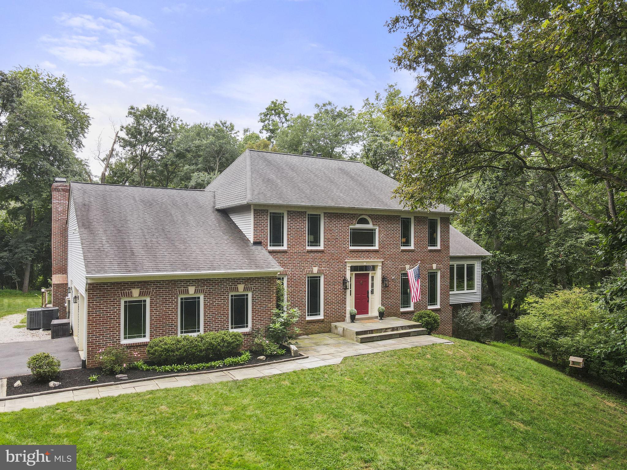 Welcome to your new home at 11609 Waples Mill Road – where luxury, privacy, and craftsmanship meet in the heart of Oakton. This exceptional brick-front colonial features four bedrooms, three-and-a-half bathrooms, and sits on a 1.6-acre wooded lot with tranquil nature views from every room. With over $225K in recent updates, the home blends classic colonial charm with modern efficiency and comfort. Step into a light-filled two-story foyer with gleaming hardwood floors. The foyer flows into a formal dining room with custom moldings and a modern chandelier — perfect for memorable dinners. Across the hall, a formal living room offers an inviting space to relax or entertain. The gourmet kitchen boasts stainless steel appliances, sleek granite countertops, and stunning views of the wooded backyard. Adjacent to the kitchen is a breakfast nook that opens into an expansive family room, where a floor-to-ceiling stone fireplace serves as a cozy focal point, complemented by vaulted ceilings and natural light from skylights and four patio doors. From the breakfast nook, step onto the TimberTech composite deck (2025) with nearly 1,000 square feet of outdoor entertaining space. The family room also opens to a tranquil screened-in porch, perfect for enjoying morning coffee or an evening breeze. The backyard is a private oasis, featuring lush landscaping, mature trees, and a gentle stream and undeveloped green space along the rear of the property. Retreat to the main-level primary suite, a haven of relaxation with a sitting area, a second fireplace, and private deck access with tranquil backyard views. This suite also boasts a walk-in closet and a spa-like en-suite bath. Upstairs, three additional bedrooms include a second primary suite with en-suite bath and double vanity — ideal for an au pair, guests or extended family. A bright home office behind double French doors could serve as a fifth bedroom. Additional highlights include an attached two-car garage, brand-new Andersen windows (2025), new carpet and paint (2025), and a new HVAC system. The unfinished basement is a blank canvas — ready for a home theater, gym, or extra storage. Despite its private setting, this home is just minutes from it all — with Waples Mill Elementary a short walk away and quick access to I-66, the Vienna Metro, parks, trails, and shopping and dining at Fair Oaks/Fair Lakes. This is a rare opportunity to own a move-in ready home with custom touches in one of Northern Virginia’s most sought-after communities and no HOA. VA Loan Assumption - 2.5% Interest Rate Assumable for Veterans!