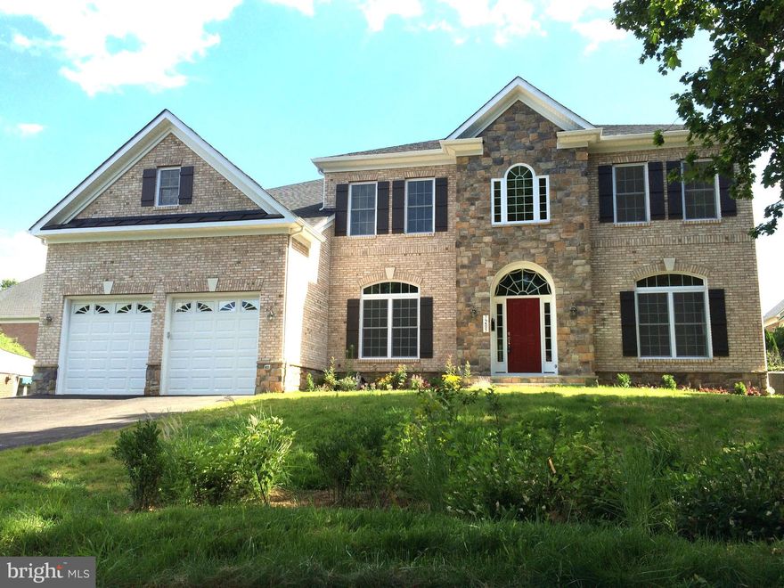 Welcome to this spectacular custom residence perfectly situated on a premium end-of-street lot in the heart of McLean. Built in 2015, this magnificent home boasts 6 bedrooms, 6 full bathrooms, and 7,660 beautifully finished square feet across three grand levels with soaring ceilings (10' main/9' upper & lower).  Pass through the striking brick-and-stone facade into a breathtaking two-story entry foyer anchored by a custom architectural rotunda and elegant 4” oak hardwood floors. The main level is designed for effortless entertaining, featuring a formal living and dining room with exquisite 4-piece crown molding, a sun-drenched morning room with French glass doors, and a spectacular family room defined by a coffered ceiling and a stone-surround gas fireplace. The gourmet chef’s kitchen is a masterpiece, outfitted with off-white custom cabinetry, a massive contrast-cherry island with a secondary veggie sink, and a commercial-grade appliance suite featuring a 48” Wolf dual-fuel range and a 48” Sub-Zero built-in refrigerator.  The upper level introduces brand-new Maple hardwood floors leading to a sprawling primary suite complete with two massive walk-in closets and a spa-like bath featuring a frameless custom tile shower and jetted soaking tub. The fully finished lower level features 9' foundation walls, an expansive recreation area, a dedicated media room pre-wired for 5.1 surround sound, a full granite wet bar, and a private au pair/guest suite. Outside, enjoy low-maintenance luxury with a Hardie-plank rear, flagstone walkways, and a private back patio. The oversized 2-car garage comes equipped with a pre-installed Tesla Wall Connector. Unbeatable walkable location—just minutes to the McLean Metro Station, McLean High School, and downtown dining/shopping with instant commuter access to I-495, I-66, and the Dulles Toll Road!