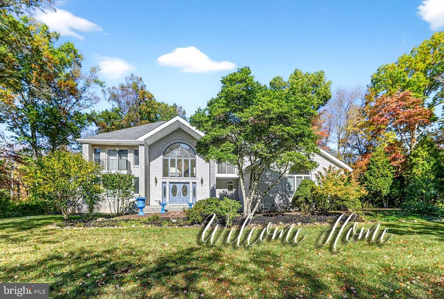 Elegance and comfort define this custom-finished contemporary colonial, clad in striking White Belgian Brick from top to bottom. Privately situated on a picturesque 1.92-acre fenced lot, the property is secured by an estate-quality Jerith fence and stately entrance gates. Bluestone front steps enhance its curb appeal, while the expansive backyard offers a park-like retreat with mature trees, open lawn, and a Trex patio deck leading to a charming gazebo—perfect for gatherings and outdoor entertaining.
Graceful statues warmly welcome guests, setting the tone for the grandeur within. A sculptural curved wooden staircase anchors the foyer with artful sophistication, complemented by a stunning European chandelier, marble, and granite floors. Designed for elegant living, the home features a distinguished library, a kitchen with a large center island and generous pantry, a formal dining room, and an expansive living room with vaulted ceiling, skylight, and a floor-to-ceiling ceramic-tile fireplace. The family room with a second fireplace adjoins an exquisite sunroom illuminated by six skylights, offering year-round light and warmth.
Upstairs, hardwood hallways lead to four spacious bedrooms, each with custom closets and private balconies—perfect for quiet mornings or starlit evenings. The main suite impresses with oversized skylights, ideal for stargazing, a fireplace for cool evenings and a spacious bath room featuring a soaking tub and separate shower. With twelve skylights and three working fireplaces throughout, the home radiates natural light and welcoming warmth.
Additional living space includes a finished multi-room basement, ideal for a home gym, office, or media room.
Located in the sought-after community of Rosedale Acres, residents enjoy exclusive access to scenic walking trails winding through meadows and fields. Just minutes from downtown Princeton and conveniently positioned midway between New York City and Philadelphia, this residence offers the perfect blend of luxury, comfort, and prestige.