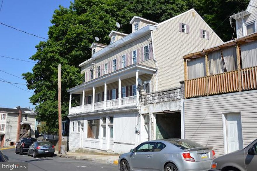 Attractive 4 unit investment property!   Three units are currently occupied and the fourth is undergoing  renovations and is to be rented soon.  211 is a nice three floor, 4 bedroom, 1 full bath home featuring new carpet, new electric water heater and new refrigerator renting at $910.00/mo.  213 features two units:  (1), one bedroom, and (1), two bedroom, both renting at $610.00/mo.  215 is also a three floor home and is currently vacant.  All separately metered electric.   There is additional income to be made from renting the storefront and/or 1 car garage which will both will require renovation.
Showings will be limited to certain days as to limit disrupting the tenants.  Noted real estate taxes are for both parcels.