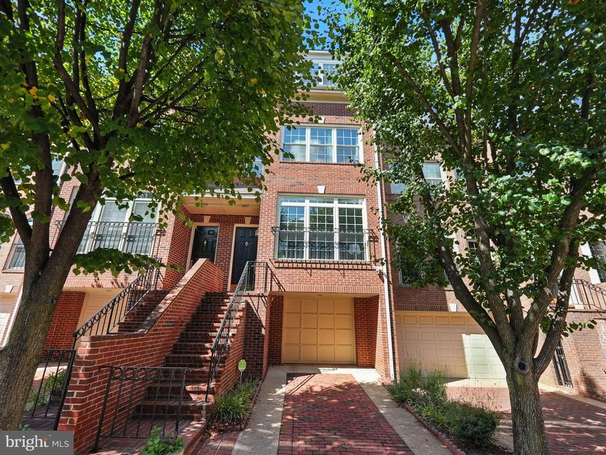 Set in the sought after community of Highgate in the urban village of Rosslyn in North Arlington. North Arlington is one of the DC region’s most coveted locations. Reagan National Airport is just minutes away, and the Metro, shops, restaurants, and grocery stores are a short walk from your door. Georgetown and Clarendon are close by for an effortless city lifestyle.

This fully renovated interior row townhouse blends classic brick Federal style with modern comfort This home welcomes you with a light filled open floor plan, gleaming hardwood floors, and two gas fireplaces, both including a double sided feature for cozy evenings or entertaining. The beautifully updated kitchen offers high end stainless steel appliances with a built in microwave, gas range, and dishwasher. Thoughtful upgrades such as dual flush toilets and energy efficient fixtures underscore a commitment to sustainability.

Upstairs you will find three spacious bedrooms and two and a half baths. The fully finished lower level with a connecting stairway and walkout adds flexible space for an office, gym, or media room. An attached oversized garage prewired for an EV charger and a brick driveway provide convenience and extra storage. The association fee covers management and common area maintenance, so you can simply enjoy elegant living in a premier North Arlington location.