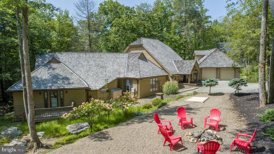 Charming Lakefront Craftsman on Stockslager Rd – This 5 Bedroom, 4.5 Bathroom lakefront estate is situated on 1.25 acres of wooded land and features a detached carriage house with a game room, sprawling back deck overlooking Deep Creek Lake, and 270’ of level lakefront. Boardwalk patio down to your Type A dock and lakeside bar. Attached 2-car garage with EV charger and an in-law suite upstairs. Tastefully updated modern kitchen with granite counters and stainless appliances. Rustic timber logs and stone fireplace in the great room. Plenty of glass throughout the main level to let in the natural light. Lots of seating/dining areas for entertaining, including a fully enclosed sunroom. Nestled into a private cove, yet minutes from local restaurants, state parks, and Wisp Resort. This eclectic modern contemporary has endless potential. Call today for your private showing!