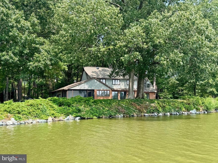 First time ever offered for sale, this premier private lot in the desirable community of Oaklands offers deep water and some of the finest views and locations in Talbot County. Perfectly sited on a highly elevated, rip-rapped shoreline with approximately 6’ MLW, the property features a waterside first-floor primary suite, a wonderful screened porch, an open kitchen and family room, a cozy den, and three additional bedrooms upstairs. Nearly every room in the home enjoys sweeping water views. A large heated and air-conditioned garage with a separate workshop, paved driveway, and mature landscaping provide both functionality and privacy. The dock includes two deep-water slips and a large floating dock, and there appears to be ample space for a pool. Ideally located between Easton and Oxford, just two miles from historic downtown Easton, the property is convenient to shopping, dining, the YMCA, parks, and more.