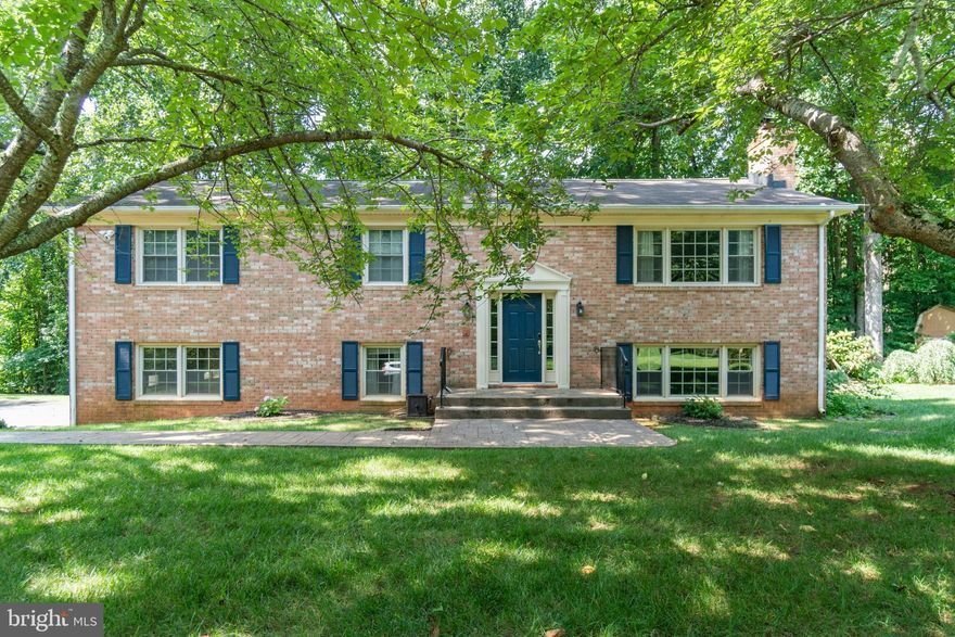 Welcome home! You will be charmed by this brick front, traditional style, split foyer in Country Wood Estates! Situated on a 1 Acre wooded lot, offering space and privacy. Newer stamped concrete walkways lead you from the driveway to the front porch. As you enter, you’ll be pleasantly surprised with warm tones and lots of natural lighting. There are modern improvements such as Tongue and Grove, wood like laminate flooring throughout, with some old charm still present like the brick fireplaces. Spacious 2100 finished sq ft with 4 bedrooms and 3 full baths! Located on the upper level you will find the Eat-in Kitchen with granite countertops, stainless appliances, and plenty of cabinets for storage. Off the Kitchen is the Living Area which has a wood burning fireplace. The Dining Area is complete with crown molding, chair railing and French doors leading to the NEW deck (2022)! It's the perfect combination for hosting family gatherings. The Primary bedroom has dual closets with extra storage space and a full bath! Also on the upper level is are two additional bedrooms and a full bath. On the lower level there is 1 additional bedroom and 1 full bath. There is also a Rec Room with floor to ceiling brick wall and a woodburning stove which will warm you on chilly winter days. Completing the lower lever is a Laundry room and Storage room which are adjacent to the large 2 car garage! HVAC 2021. This amazing home is move in ready! Close to commuter lots, NO HOA you have the perfect combo of country living yet close to schools, shopping, and I-95!