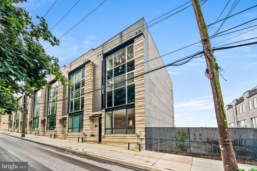 If living in one of the hotest places to reside ,close to center city, is your desire- this amazing townhome,  in Manayunk, is it.  Enter the welcoming foyer to the modern open floor plan featuring  11 foot ceilings.   The kitchen features high end Thermador appliances, large quartz island, built-in microwave and separate dining area.   Adjacent is the large great room with a linear gas fireplace  surrounded by  custom built-in shelving and cabinetry and a wall of La Cantina Accordion style glass doors which open to the convenient deck with expandable awning.  The second floor is dedicated to the huge primary suite with  a wall of windows that has access to the deck, large closets and a dream primary bath with full wall shower plus stand alone tub, 2 separate vanities ,plus 2 separate water closets- a great place to retreat after a long day.    Three additional bedrooms plus 2 full baths and a convenient laundry room with sink and cabinetry compliment the third floor.  The roof top level features a green roof system with self-feed soil and a beverage center with cabinetry, sink and  beverage refrigerator, a great place to retreat at end of day.  The lower level is home to the  2-car attached  garage plus bonus space that can serve many uses. such as a work out space, play area or storage. .     Amenities in this dream home include: wood flooring throughout, 5 stop elevator, gas heat, tankless water heater, dual zone HVAC to name a few.    Location can't be beat - not only witihin minutes of center city - Manayunk has its own special attributes: the amazing Towpath along the Schuylkill River,  shopping in the cool Main St boutiques and dining at over 30 restaurants make this fabulous townhome the perfect place to call home.  Please note - Tax abatement in effect until 4/2030 - no flood insurance needed !   Make your appointment  today.
