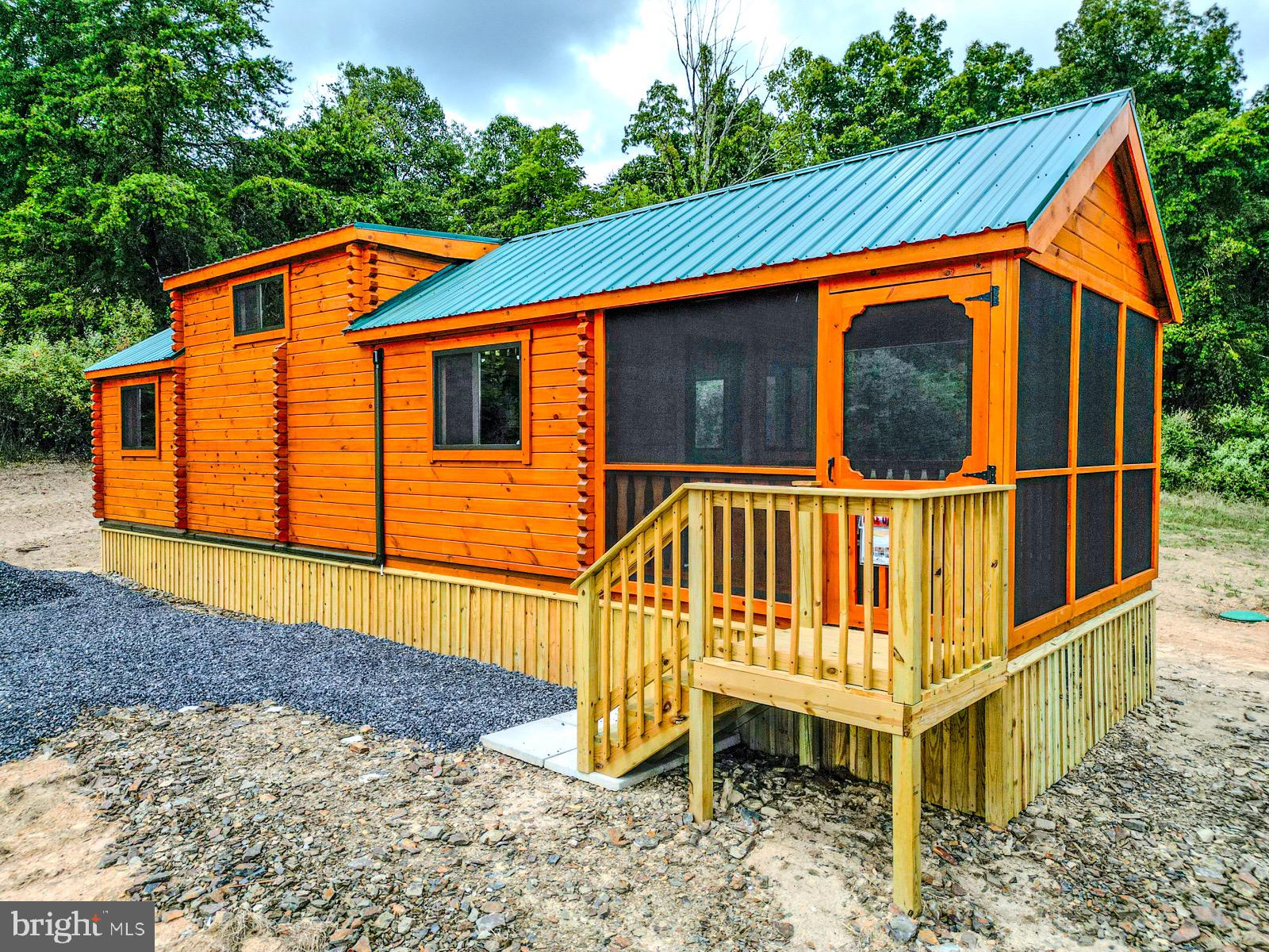SELLER MOTIVIATED - BIG PRICE REDUCTION!! **Rustic Yet Contemporary Tiny Home Log Cabin in the Heart of the Appalachian Mountains** Discover the charm and freedom of living in a true log cabin nestled in the heart of the Appalachian Mountains. This property offers no HOAs to burden or infringe on your freedoms! Whether you're just starting out as a homeowner or considering a real estate investment, you can't go wrong with this delightful cabin. Owning this property is less expensive then current rental payments. Investors - the STR opportunities are endless here! Rustic Yet Contemporary Design! With functional use of space every inch of this cabin is designed with practicality in mind. Relax and enjoy the outdoors year-round in any weather on your spacious enclosed porch. The living area offers ample space for a comfortable retreat after a day of adventure. The fully functional Kitchen includes a breakfast bar for casual dining, all the necessary appliances for convenience with sufficient counter and cabinet space. Full sized bathroom equipped with all the essentials for everyday living. The Main Bedroom is 12x10 (approx) and can accommodate a king or queen bed with ease or 2 doubles. Washer/Dryer Hookups are included. There is a Computer/Desk/Storage Area that can easily accommodate bunk beds for additional sleeping arrangements if needed or be utilized as a pantry or large closet. The massive loft 11x17 (approx) provides space for two queen mattresses, perfect for guests or extra family members. Mini Split Heat/AC for efficient heating and cooling for year-round comfort that is reliable and convenient. Metal roof with gutters and downspouts to keep the cabin well-maintained. Hassle free public water supply. All situated on an easily maintainable 1.35 acre lot located perfectly near all that West Virginia has to offer, including skiing, fishing, boating, hunting and hiking. Just minutes off Corridor H/US 48 and close to popular attractions such as Seneca Rocks, Davis/Thomas, Spruce Knob, Vepco Lake, Potomac River, Canaan Valley Ski resorts and Blackwater Falls. This delightful, affordable, and sensible investment is perfect for anyone looking to embrace the Appalachian lifestyle. Don't miss out on the opportunity to own a piece of mountain paradise before it's gone!!! ** Seller will contribute a new Residential Starlink Kit with full price offer **