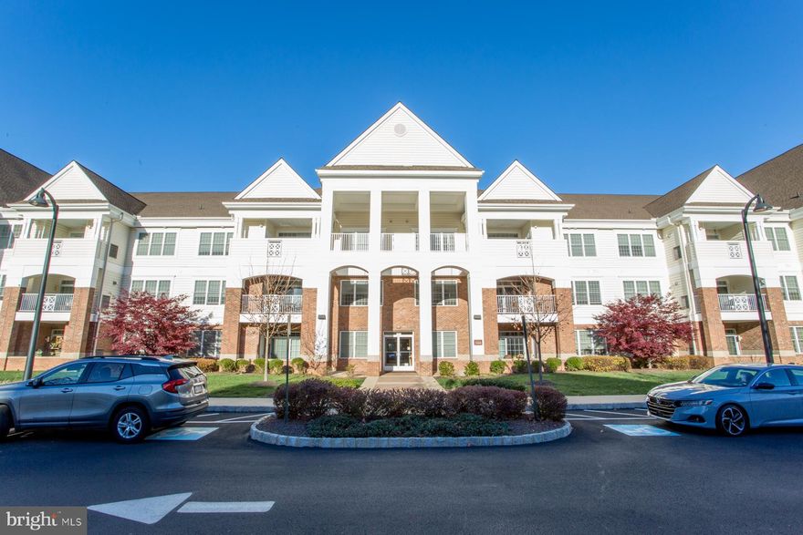 This stunning, light-filled 2 bedroom, 2 bath, second floor condo is located in the newer section of Meridian Valley Square, where one can lead an active, luxurious and secure lifestyle in this exclusive 55+ community in beautiful Bucks County.  The condo has been freshly painted throughout and adorned with many new lighting fixtures.  A unique feature of this very desirable condo is the extra room off the kitchen which could be an office, den, or even an extra guest bedroom. The gourmet kitchen boasts high-end stainless steel appliances, including a gas range, as well as subway tile backsplash, custom white cabinetry, gorgeous granite countertops and island with seating for 4, and new custom pendant lighting.   The comfortable, open concept living room and dining area features 9 ft. ceilings, gleaming hardwood floors, a dry bar, and a corner fireplace with custom tile surround.  Access the large private balcony through sliders and enjoy the scenery.  Additional custom features include recessed lighting, ceiling fans, custom closets, and crown molding. The spacious primary suite has everything one needs--sitting area with room for an office, three large closets including one walk-in,  newly installed premium carpeting, and a bath with double sinks, stall shower with seat, and custom vanity. The second bedroom, also with new carpeting, is large and bright and adjacent to the second, recently updated, full bath. Next to this bathroom is the laundry room with a tub sink and washer/dryer hook-ups.  In addition to an oversized garage with shelving, there is a private storage area for this unit, also with extra shelving. This pet friendly community offers many amenities including secure entrances, walking and jogging trails, large outdoor saltwater pool, and a clubhouse with billiard room, fitness center, library, and more. Walk to Wegman's Food Market and the shops and restaurants at Valley Square. Easy access to major commuting routes and a short drive to Doylestown Boro with all it has to offer.