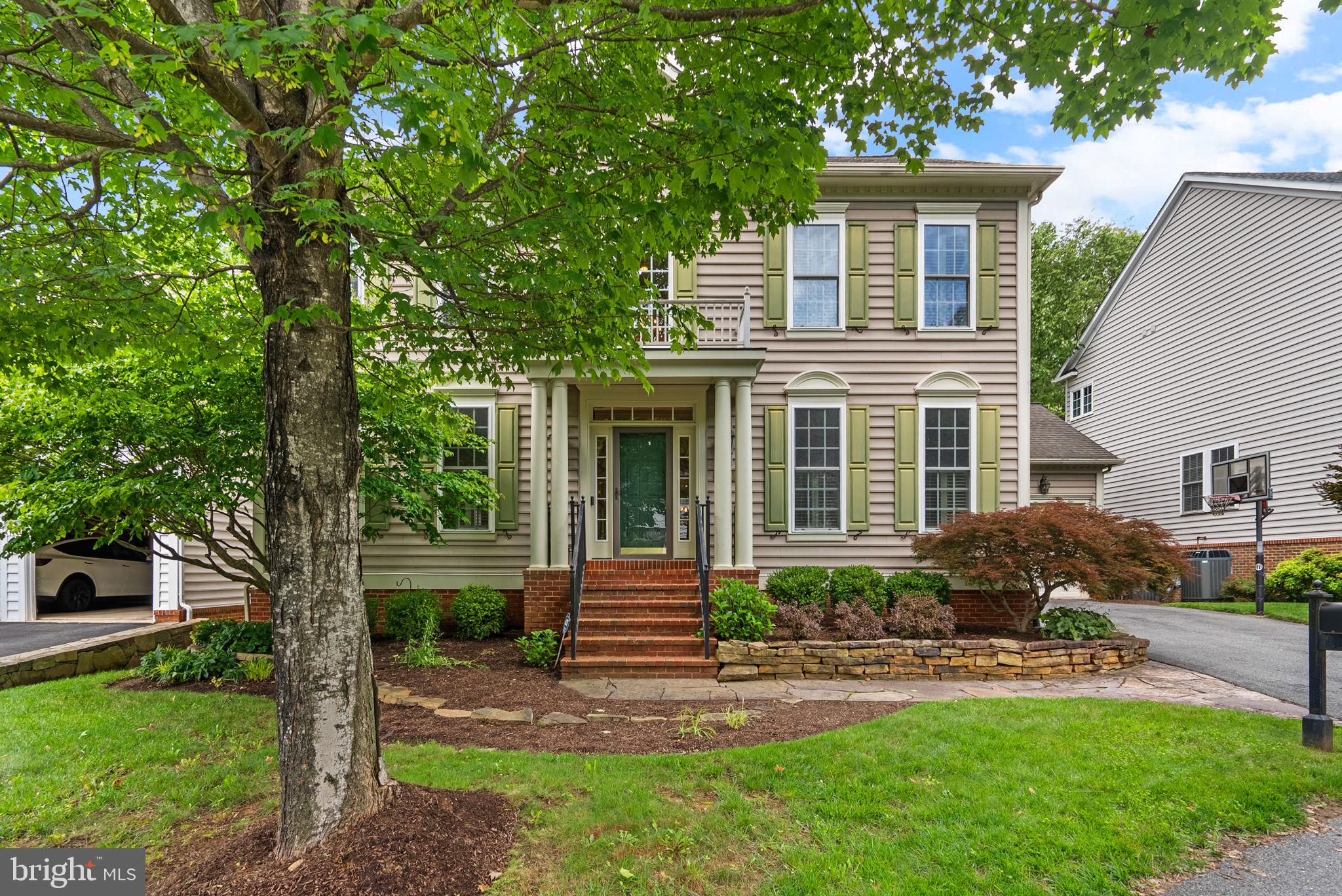 Welcome to this stunning NV-built Dartmouth model, beautifully situated in the prestigious Lane in the Woods section of the Lakelands community. From the moment you step into the impressive foyer with a dramatic double staircase, you’ll be captivated by the elegant craftsmanship and attention to detail throughout. The first floor features a formal Living Room adorned with crown molding, recessed lighting, and classic wood shutters—a welcoming space for relaxing or entertaining. Just off the foyer, French doors lead to a private study featuring a custom wall unit and wood shutters. The formal Dining Room is equally striking with a tray ceiling, box panel wainscoting, and chair molding—perfect for hosting special gatherings. The heart of the home is the breathtaking center island kitchen, offering recessed lighting, a top-of-the-line GE Café double oven with convection, induction cooktop, GE Cafe French Door refrigerator, large pantry, and generous breakfast area. A French door opens to a spacious rear deck, ideal for entertaining while enjoying views of the beautifully treed lot. The enormous Family Room features a cozy gas fireplace, recessed lighting, and a wall of windows that bathe the space in natural light and frame picturesque backyard views. A Butler’s Pantry with extra cabinetry, stylish Powder Room, and access to a 2-car garage complete the main level. The main level has gleaming hardwood flooring throughout. Upstairs, the Primary Suite is a luxurious retreat, offering hardwood flooring and a tray ceiling. The Primary Bathroom includes a two vanities, glass-enclosed shower, and separate soaking tub—perfect for relaxing in comfort. The second bedroom is en-suite with its own full bath and ceiling fan. Bedrooms three and four share a beautifully updated Jack-and-Jill bathroom with 2 quartz vanities and glass-enclosed tub/shower. A convenient Laundry Room with shelving and a linen closet rounds out the upper level. The walkout lower level is a true showstopper! Enjoy a large recreation room with a stunning brick feature wall, perfect for entertaining. The custom bar is equipped with granite countertops, pendant lighting, two beverage refrigerators, and a stainless undermount sink. There’s also an exercise area with walkout access, a den with a closet, and a huge unfinished storage room with extra shelving. All of this plus access to Lakelands’ top-tier amenities: pools, tennis courts, playgrounds, fitness center, and scenic walking paths. Don't miss this truly special home. Open House Sunday, August 24th 1:00-4:00.