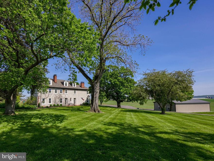 Discover Lancaster County living at its finest. This charming historical farmhouse sits on 7.734 acres of picturesque land. Approach this idyllic retreat via a beautiful, long driveway, refinished and paved for easy access and enhanced curb appeal.  As you step inside the front door you will discover meticulously refinished original plank hardwood floors and woodwork throughout, showcasing the craftsmanship of yesteryear. To your right awaits a full library, thoughtfully utilized as a home office space, offering a quiet retreat for work or study. On the left, another room serves as an additional home office, providing flexibility and convenience. Continuing down the hallway, a sense of warmth and hospitality envelops you as you're greeted by a formal living room on the left, exuding elegance and charm. Beyond the formal living room lies a spacious family room, inviting gatherings and relaxation with its cozy ambiance. Each first-floor room beckons with its own unique character, inviting you to explore and create lasting memories.
The heart of this historical farmhouse is where the kitchen stands as a testament to both functionality and beauty. Adorned with exquisite handmade Shaker Amish cabinets stretching from floor to ceiling, this kitchen exudes timeless elegance and craftsmanship. The floating island, complete with a stove top fill-in, serves as a focal point for culinary creativity, offering ample space for meal preparation and casual dining. Also, you will find a convenient half bath in the kitchen for family and guests. As you cook, entertain, or simply enjoy a cup of coffee, you'll be captivated by the stunning views visible from the kitchen windows and the French doors to the adjacent back deck. Enhance your evenings with the warmth and ambiance of seven woodworking fireplaces throughout the entire home including a walk-in hearth in the Kitchen with one-of-a-kind touches, such as a brick built in bread oven adding a touch of classic charm to every gathering.  Two separate staircases lead you to your destination upstairs. With five spacious bedrooms and three full baths, this residence seamlessly blends historic charm with traditional comfort. Retreat to the two master bedrooms on the South wing of the home complete with a private balcony offering sweeping views of the surrounding landscape. The North wing of the home boasts three large bedrooms with charming touches such as exposed brick and natural light.  Additionally, both the wings include private entries to a large wrapping balcony, perfect for enjoying morning coffee or evening stargazing. Three full bathrooms upstairs allow for convenience and ease. Two of the three bathrooms include original porcelain clawfoot tubs, a testament to the timeless elegance of this historical gem.  The large master bathroom has been recently restored with a custom stone dual showerhead walk-in shower and double vanity.  Upstairs above the second floor you will be amazed at the potential of the full attic with five dormers and how you could transform it into a grand loft room or live in quarters. Complementing the historical farmhouse is a brand new, stunning four-bay pole building barn, offering ample space for storage, hobbies, or potential conversion into additional living quarters.  Enjoy breathtaking scenic views from every angle, complemented by the convenience of being backed up to a private airport. Ideal for aviation enthusiasts and small business owners alike, this property offers a unique opportunity with its proximity to the Donegal Springs Airport directly behind the home. Whether you're a seasoned pilot or an aspiring aviator, having a runway at your doorstep provides convenience. An easy 20-30 minute commute to Lancaster, Harrisburg and York.  With a short drive to the Mount Joy and Elizabethtown Amtrak stations.  Furthermore, this home offers an exceptional setting for raising a large family or nurturing children in the vibrant community of Lancaster County.