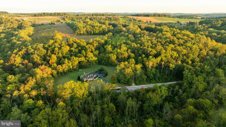 (Recently Appraised for $2.28M)
Tucked into the rolling hills of Codorus Township in York County, this 145.12+/- acre property blends certified organic farmland, expansive woodlands, and a meticulously designed residence to create a setting for both living and recreation.

The current owner became only the second steward of this estate in 2017, beginning with 92+/- acres. Over time, adjoining parcels were acquired, expanding the holding to its present 145+/- acres and shaping the private property it is today.

For more than seven years, the land has been managed organically and remains free of preservation restrictions, offering flexibility for farming, homesteading, or future use. Multiple creeks and springs flow through the valleys, while 35+/- acres of tillable ground provide space for crops or pasture. Over 100 acres of timber rise across the hillsides, creating both habitat and potential timber value. Whitetail deer, wild turkey, and other wildlife are EVERYWHERE, supported by the mix of food, water, and cover. Nearly 10 miles of established trails weave throughout, allowing for ATV use, horseback riding, hiking, or quiet walks into shaded hollows.

At the heart of the property, set atop a hill with sweeping south-facing views, is a Cape Cod style home built in 2007 with 2,936+/- finished square feet. The home was meticulously planned with efficiency, storage, and future flexibility in mind. The main level features a spacious kitchen and formal dining area that flow into a living room anchored by a stone propane fireplace. A primary suite with dual closets and a private bath, along with a first-floor laundry room, add convenience. Upstairs, three additional bedrooms and a full bath provide ample accommodations.

The home showcases the quality of construction. Built with insulated concrete forms, the foundation provides strength, efficiency, and comfort. Nine-foot ceilings, a walkout entrance, and plumbing already in place make the basement well-suited for a future in-law suite if desired. The layout was designed with storage in mind, offering generous space as well as walk-behind access to plumbing and electrical for convenience throughout the home.

Every detail of the home reflects careful thought. The entire structure is spray-foam insulated for maximum efficiency. All major mechanicals have been recently updated, including the furnace, water heater, central air, and a water purification system. A 20kw whole-house generator ensures peace of mind, while LED lighting contributes to reduced energy costs.

Supporting structures expand the property’s functionality. A 60x80 pole building with four 14x12 electric overhead doors offers exceptional storage or workspace. Additional facilities include a 30x40 greenhouse, multiple sheds, and an oversized two-car attached garage with an additional detached garage.

For recreation, the property offers more than open fields and timber. A private shooting range with both 300-yard and 700-yard lanes is established on-site, designed for everything from close-range handgun practice to long-range rifle training. Combined with the extensive trail network and wildlife habitat, the land provides diverse opportunities for outdoor enjoyment.

The property is enrolled in Pennsylvania’s Clean and Green program, keeping annual taxes reduced to approximately $8,914. Located in the highly desirable Southern York School District, it offers rural seclusion while remaining convenient to nearby towns. Glen Rock is just 5 miles away, Shrewsbury 8 miles, York 15 miles, and the Maryland line less than 10 miles south, providing commuter access to Baltimore and beyond.

With its organic farmland, south-facing views, thoughtfully designed residence, updated systems, and a mix of recreational and agricultural features, this property offers a rare opportunity to step into a landscape built for both living and working the land.

All oil, gas and mineral rights convey with the sale.